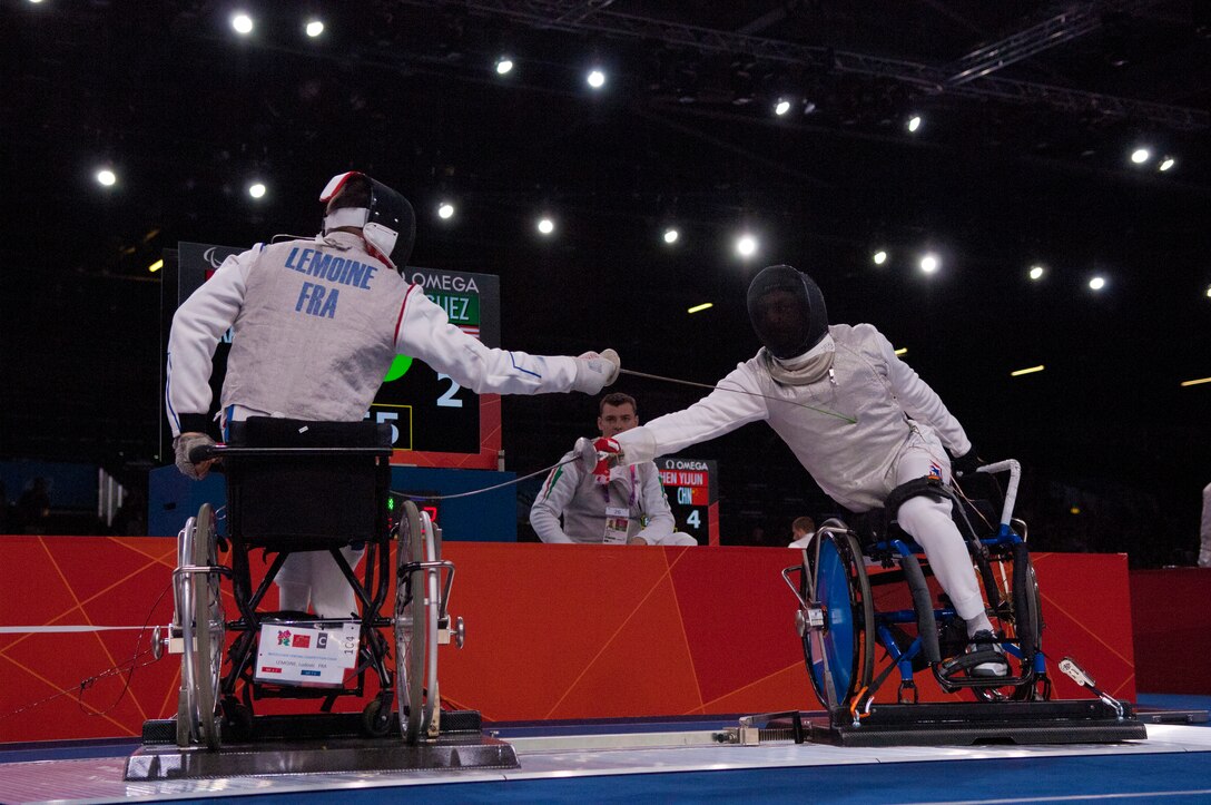 Former Air Force Staff Sgt. Mario Rodriguez, right, a member of the 2012 U.S. Paralympic fencing team, engages France's Ludov LeMoine during a bout at London's ExCel Centre during the Paralympic Games, Sept. 4, 2012. (DOD photo/Sgt. 1st Class Tyrone C. Marshall Jr.)  
