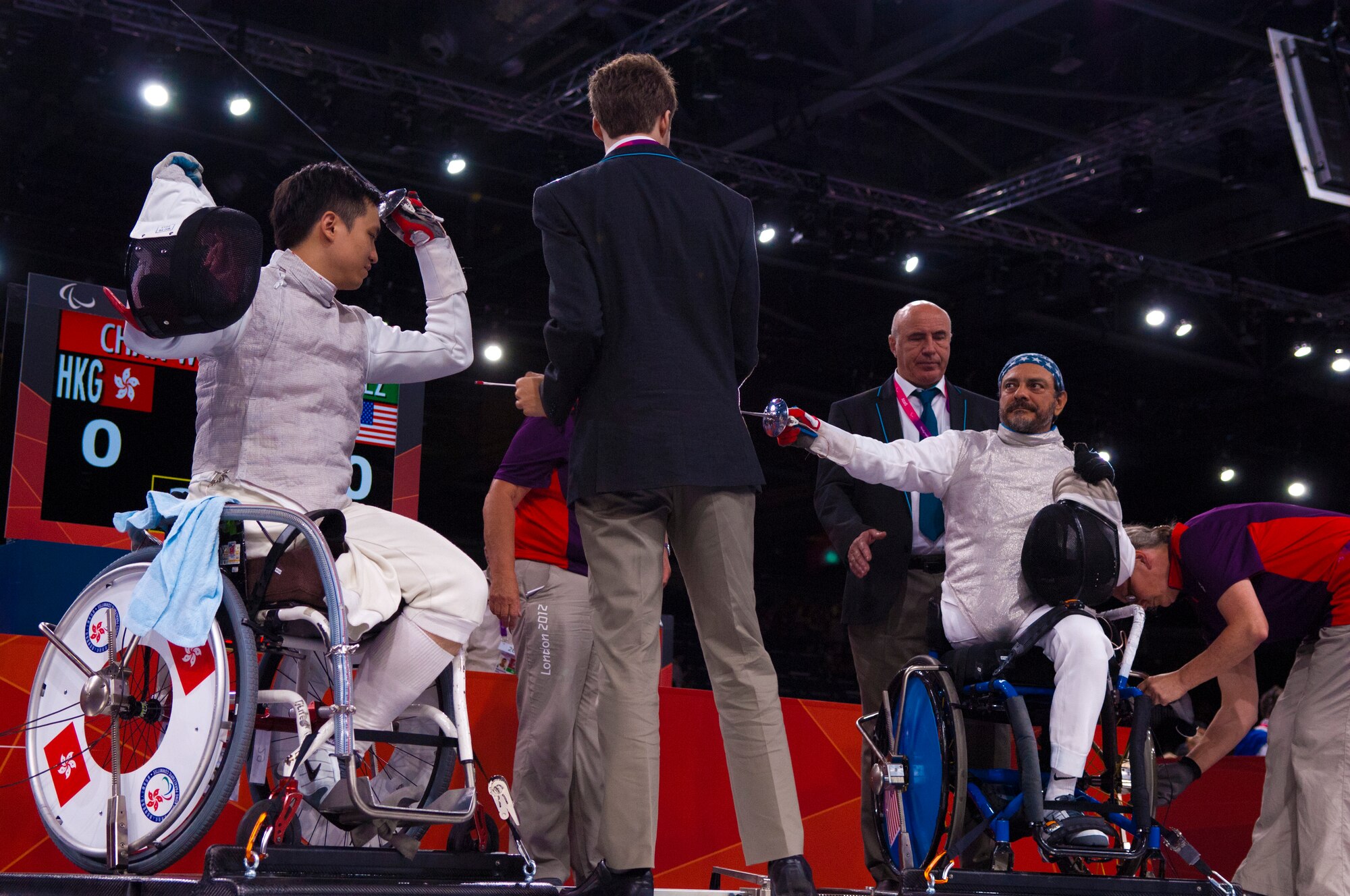 Former Air Force Staff Sgt. Mario Rodriguez, right, a member of the 2012 U.S. Paralympic fencing team, prepares to enter a bout with Wing Kin Chan of Hong Kong as officials measure the distance between the two athletes at London's ExCel Centre during the Paralympic Games, Sept. 4, 2012. (DOD photo/Sgt. 1st Class Tyrone C. Marshall Jr.)  
