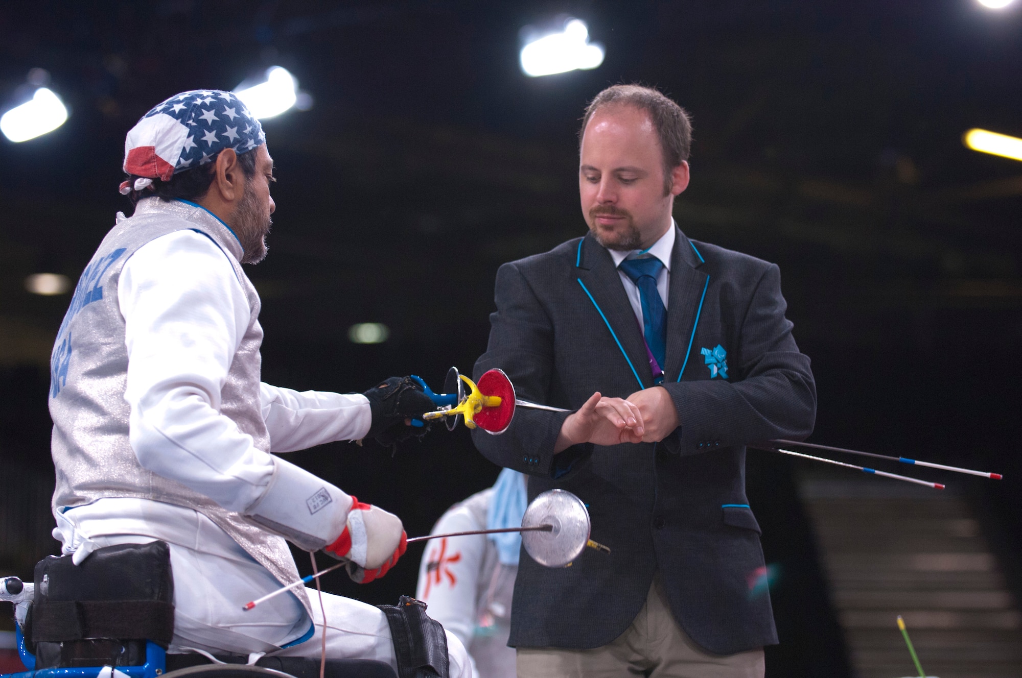 Former Air Force Staff Sgt. Mario Rodriguez, left, a member of the 2012 U.S. Paralympic fencing team, selects his weapon before the start of a bout at London's ExCel Centre during the Paralympic Games, Sept. 4, 2012. (DOD photo/Sgt. 1st Class Tyrone C. Marshall Jr.)  
