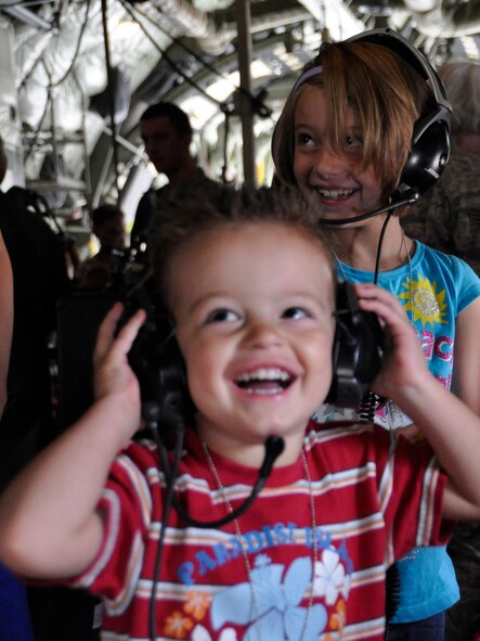 Phillip and his sister Aliya get a kick out of the 34th Aeromedical Evacuation Squadron’s wireless headsets during the 302nd Airlift Wing’s Herc Adventure Tour event Aug. 4, 2012, at Peterson Air Force Base, Colo. The Herc Adventure Tour also offered the children of AF Reservists the opportunity to experience the wing’s aeromedical evacuation mission, check out the survival gear of C-130 flight crews and sit in the pilot’s seat of a C-130 Hercules. The tour is part of the wing’s annual Family Day event. Phillip and Aliya are the children of Capt. Phillip Purcell who is assigned to the 731st Airlift Squadron. (U.S. Air Force photo/Staff Sgt. Stephen J. Collier)