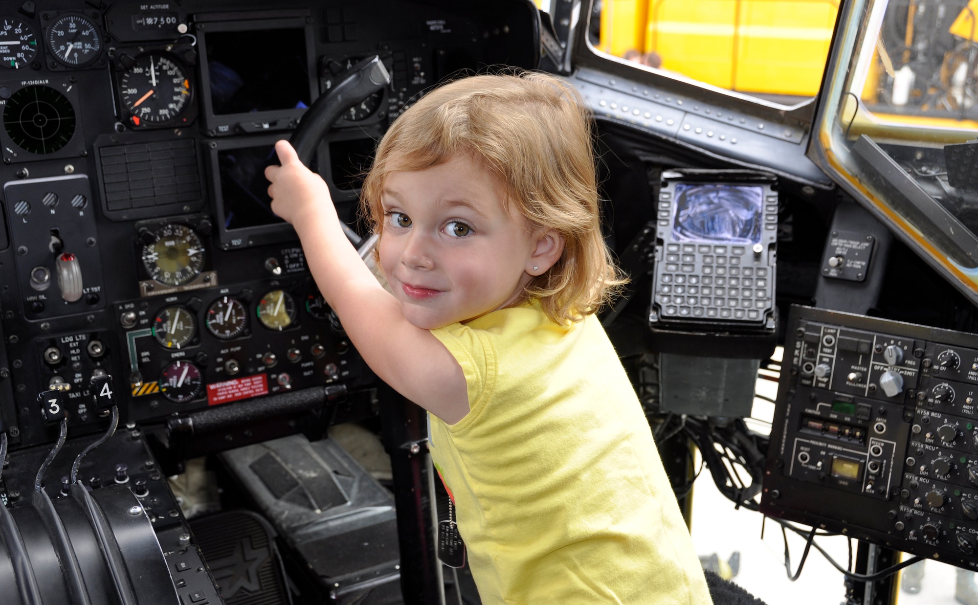 Stella, 4, takes a break from checking out her dad’s job of being a C-130 pilot during the 302nd Airlift Wing’s Herc Adventure Tour event Aug. 4, 2012, at Peterson Air Force Base, Colo. The Herc Adventure Tour also offered the children of AF Reservists to experience the wing’s aeromedical evacuation mission, check out the survival gear of C-130 flight crews and sit in the pilot’s seat of a C-130 Hercules. The tour is part of the wing’s annual Family Day event. Stella is the daughter Maj. Kevin Baylis, a 731st Airlift Squadron C-130 Hercules pilot. (U.S. Air Force photo/Staff Sgt. Stephen J. Collier) 