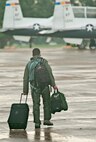 An aircrew member from the 479th Flying Training Group at Naval Air Station Pensacola, Fla., steps to his aircraft for departure, August 31, 2012.  The aircraft and accompanying aircrew had evacuated to JBSA-Randolph in anticipation of Hurricane Isaac. (U.S. Air Force photo by Benjamin Faske)