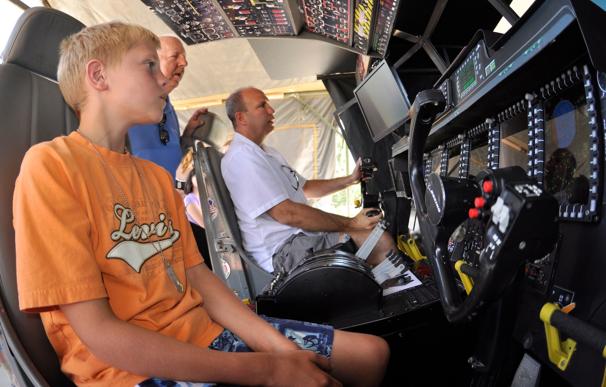 Lukas, 11, anxiously awaits his turn at “flying” a C-130 Hercules in a Lockheed Martin aircraft flight simulator at the 302nd Airlift Wing Family Day event Aug. 4, 2012, at Peterson Air Force Base, Colo.  Hundreds of Air Force Reservists assigned to the 302nd AW and their families enjoyed several activities during the annual event, including a Herc Adventure Tour, a display of military weaponry and a picnic lunch. This year’s Family Day also featured a bungy trampoline and a C-130 Hercules simulator. Lukas is the son of Tech. Sgt. Brandilen Leary who is assigned to 302nd Maintenance Group. (U.S. Air Force photo/Staff Sgt. Stephen J. Collier)