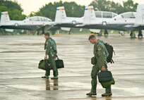 Aircrew members from the 479th Flying Training Group at Naval Air Station Pensacola, Fla., step to their aircraft to depart for their home station, August 31, 2012.  The aircraft and accompanying aircrew had evacuated to JBSA-Randolph in anticipation of Hurricane Isaac. (U.S. Air Force photo by Benjamin Faske)