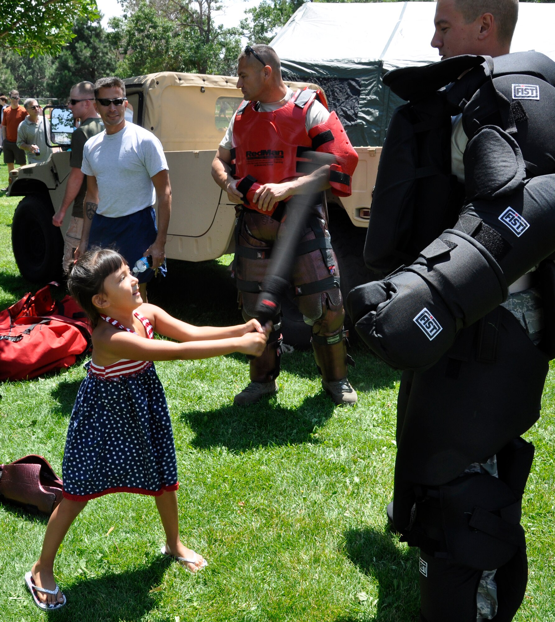 Cheyenne, 6, “fights off” Air Force Reservist Senior Airman Shane White during a security forces demonstration at the 302nd Airlift Wing Family Day event Aug. 4, 2012, during at Peterson Air Force Base, Colo.  Hundreds of Air Force Reservists assigned to the 302nd AW and their families enjoyed several activities during the annual event, including a Herc Adventure Tour, a display of military weaponry and a picnic lunch. This year’s Family Day also featured a bungy trampoline and a C-130 Hercules simulator. Cheyenne is the daughter of Tech. Sgt. Hope Lira-Ornelas, 302nd Security Forces Squadron fire team leader. (U.S. Air Force photo/Staff Sgt. Stephen J. Collier)