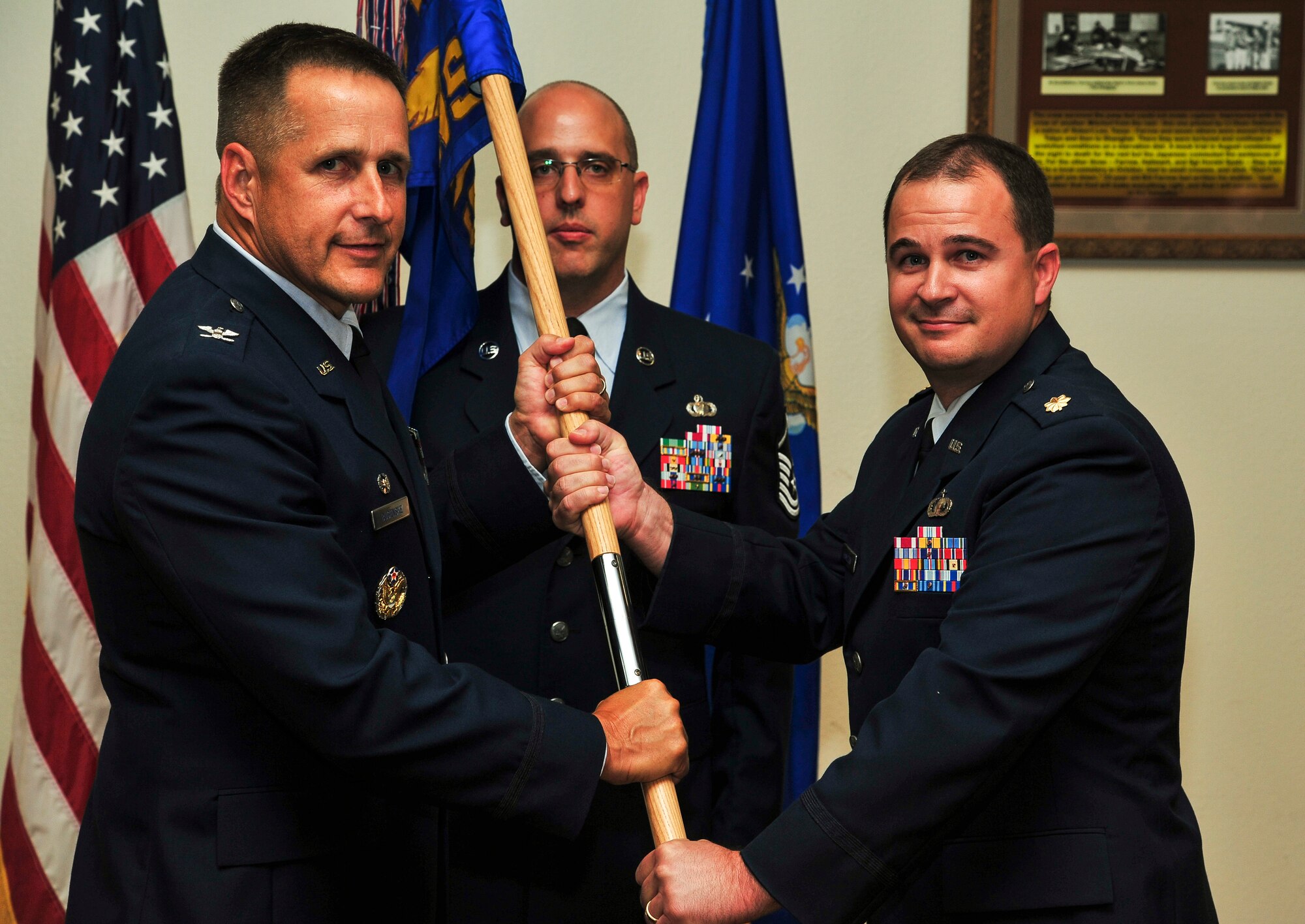 GOODFELLOW AIR FORCE BASE, Texas-- Col. Paul Bugenske, 17th Mission Support Group commander, passes the 17th Contracting Squadron guidon to Maj. Seth Hamilton, during an assumption of command ceremony at the Event Center Aug. 29. Hamilton assumed command of the 17th CONS from Maj. Garrett Truskett. (U.S. Air Force photo/Airman 1st Class Michael Smith) 