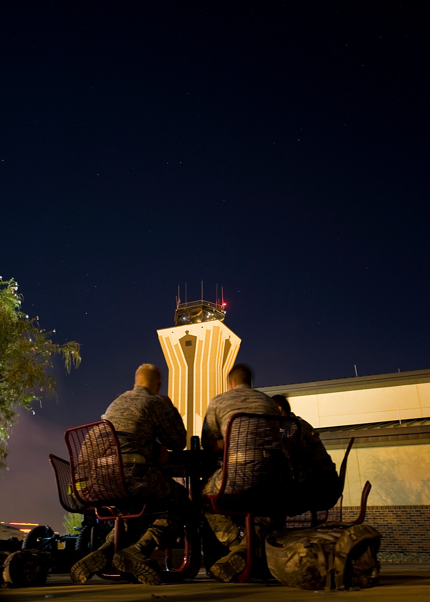 Dyess servicemembers help themselves to burgers and hotdogs during a midnight barbecue Aug. 29, 2012, at Dyess Air Force Base, Texas. The barbeque was held by the Dyess first sergeant’s group and chaplain team for Dyess personnel working swings and mid-shifts.  (U.S. Air Force photo by Airman 1st Class Damon Kasberg/Released)