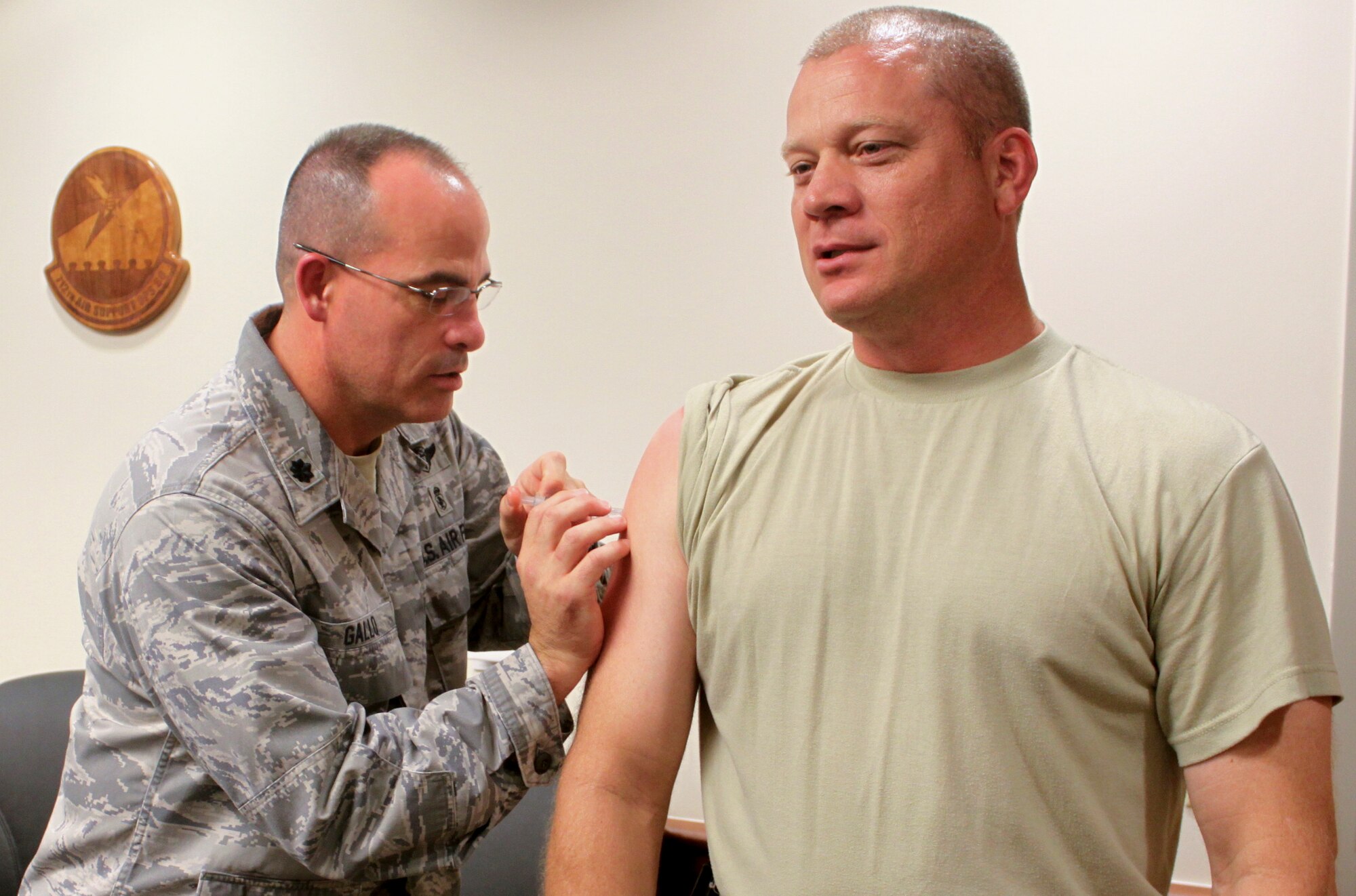 U.S. Air Force Col. Samuel Milam, 93d Air Ground Operations Wing commander, receives a flu vaccination from Lt. Col. Louis Gallo, 23d Medical Operations Squadron commander, at Moody Air Force Base, Ga., Aug. 30, 2012. The 23d Medical Group Immunizations Clinic will be providing Influenza Vaccinations to all retirees, dependents, and civilian personnel beginning September 24. (Contributed photo/Released)
