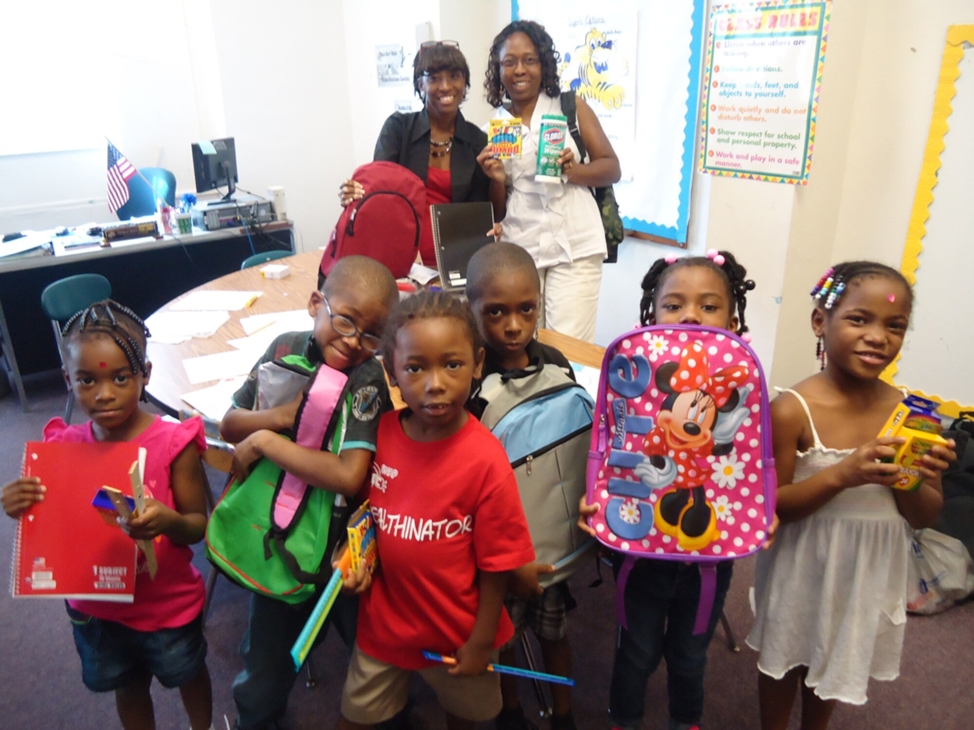 Pauline Champion (right) stands with kindergarteners and Ms. Moore from Dillard Academy. Champion, a civilian with the 916th Operations Support Squadron, helped organized the school supply drive at the 916ARW. (USAF courtesy photo)