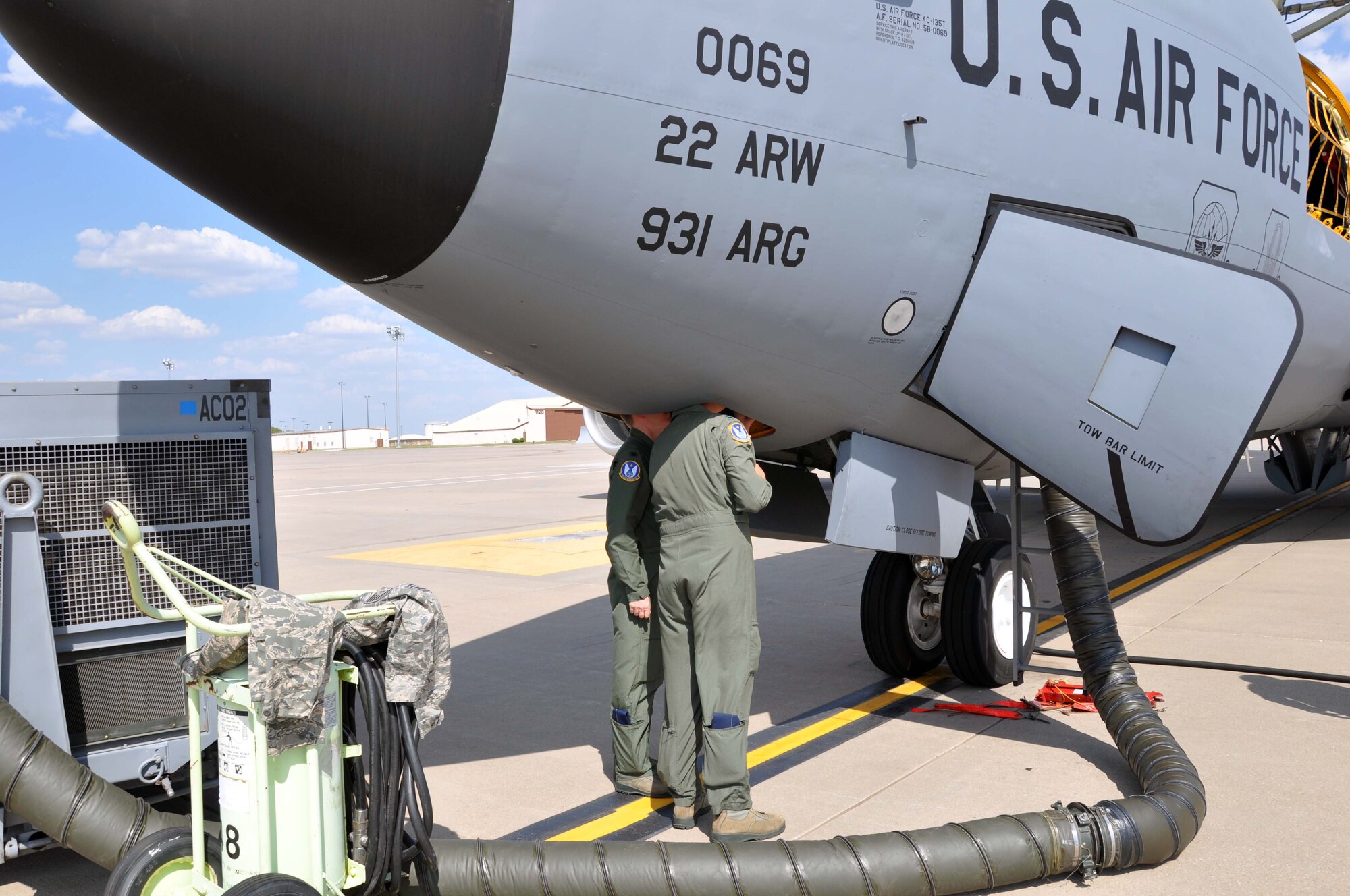 A pair of pilots assigned to the 18th Air Refueling Squadron, 931st Air Refueling Group, inspect a KC-135 Stratotanker on the flight line prior to takeoff at McConnell Air Force Base, Kan.  The KC-135 provides the core aerial refueling capability for the U.S. Air Force and has been performing in this role for more than 50 years. (U.S. Air Force photo by 1st Lt. Zach Anderson) 
