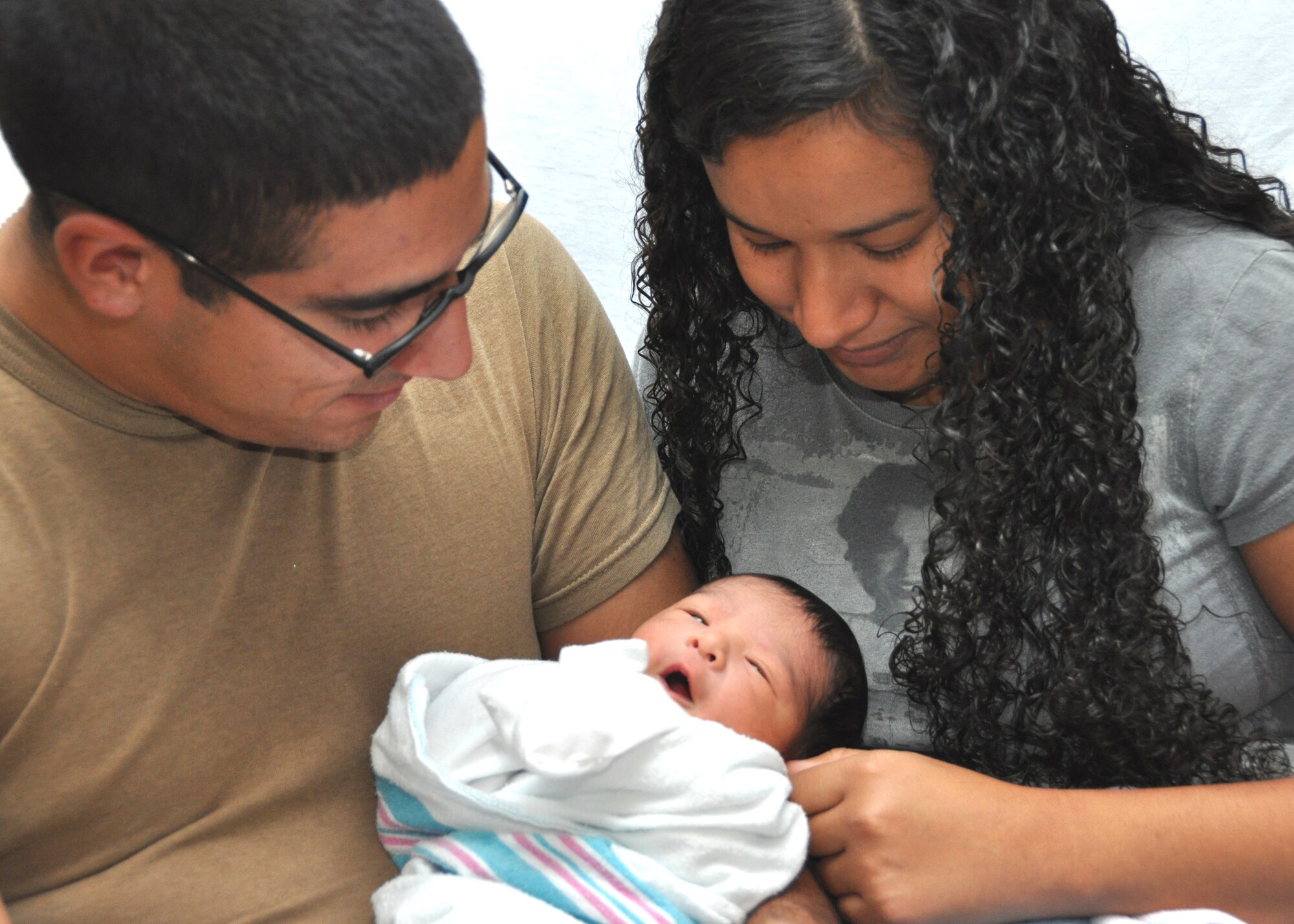 Parents Miriam and Petty Officer 3rd Class Bryan Castrellon, Naval Construction Battalion Center Gulfport, watch their first child Micheal Anthony in the Keesler Hospital’s Family Birthing Center Aug. 30, 2012, the day after his birth, at Keesler Air Force Base, Miss.  (U.S. Air Force photo by Steve Pivnick)