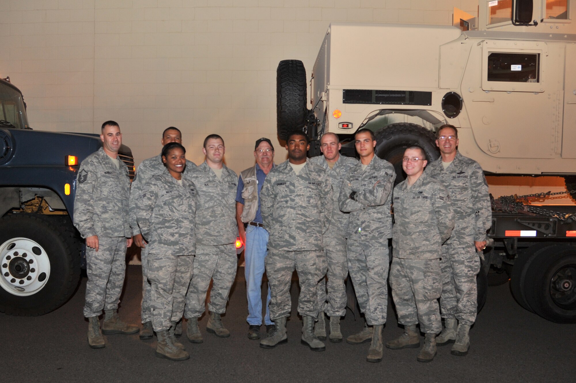 MINOT AIR FORCE BASE, N.D. -- The 5th Logistics Readiness Squadron Vehicle Operations Control Center, is a 61-person shop & a critical piece of the Team Minot puzzle. They manage a $15 million vehicle fleet of 199 Government Motor Vehicles, providing customer service to 2 wings. The VOCC also manages 3 installation programs (GMV Licensing, GMV Misuse & Training Validation & Operations). Additionally, they play a large role in the Installation Deployment Machine & have their hands in everything from Distinguished Visitor support to wrecker runs. In this photo taken at 5:30 a.m., the VOCC had already loaded 6 tractor trailer combinations with 12 HMMWVs, given their convoy brief and are headed out for a road trip to Montana. The convoy team started the 3-day operation on Aug. 27 and moved 13 HMMWVs as part of a 33 HMMWV command-leveling initiative, saving the Air Force $80,000 in commercial shipping costs. (U.S. Air Force photo/Senior Airman Brittany Y. Auld)