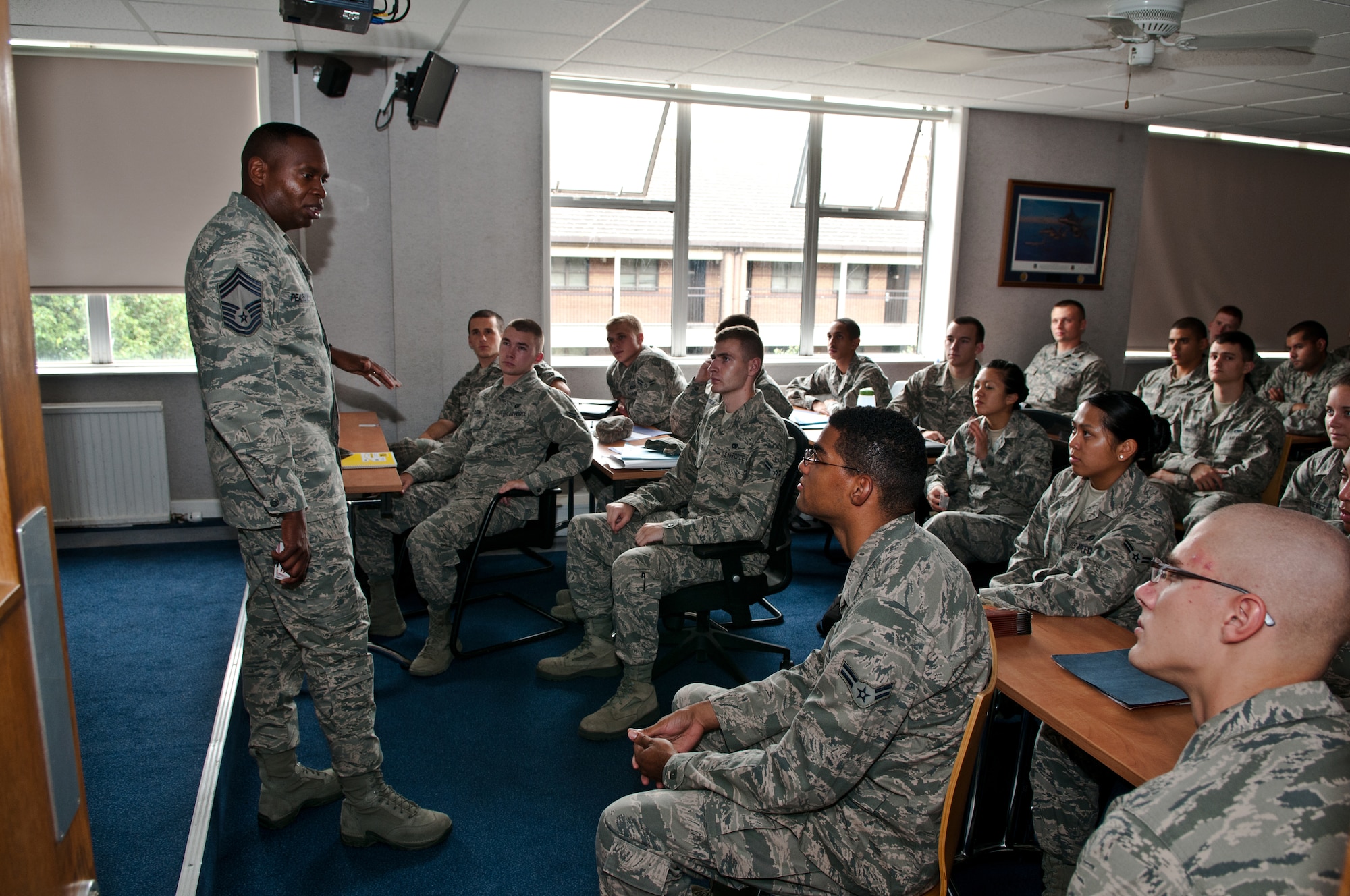 ROYAL AIR FORCE LAKENHEATH, England - Chief Master Sgt. Tony Pearson, Army and Air Force Exchange Service senior enlisted advisor, talks with students at the First Term Airmen Center about their thoughts shopping at the Base Exchange Aug. 28, 2012.  During his visit, Pearson toured most of the Exchanges in the U.K. and met with customers, Exchange associates and FTAC. When Airmen shop at the Exchange, a portion of the money spent returns to U.S. Air Force programs. Last year RAF Lakenheath Air Force Service’s activities received more than $547,000. (U.S. Air Force photo by Senior Airman Connor Estes)