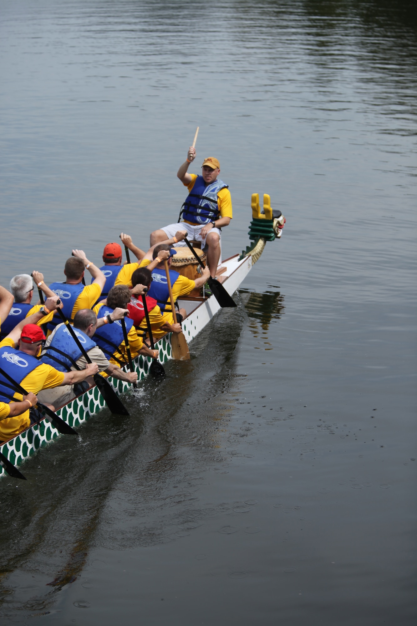 The Air War College team paddles to the start line for their first race of the Montgomery Dragon Boat Festival Saturday.