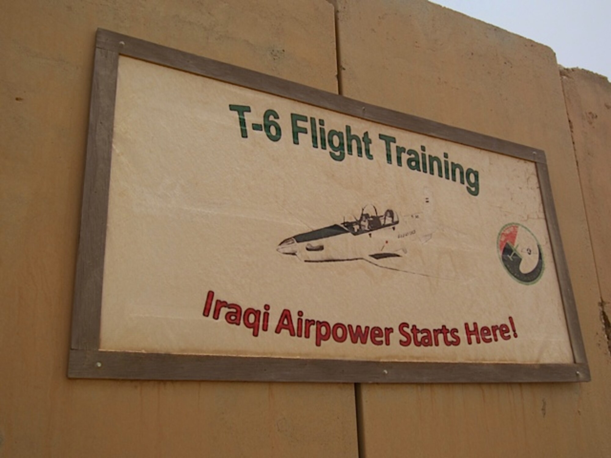 A sign showcasing one of the training missions for the Iraqi Air Force in Tikrit, Iraq. In addition to pilot training, the base at Al Sahra oversees the training of Iraqi’s future maintainers and air traffic controllers. (Contributed photo)   