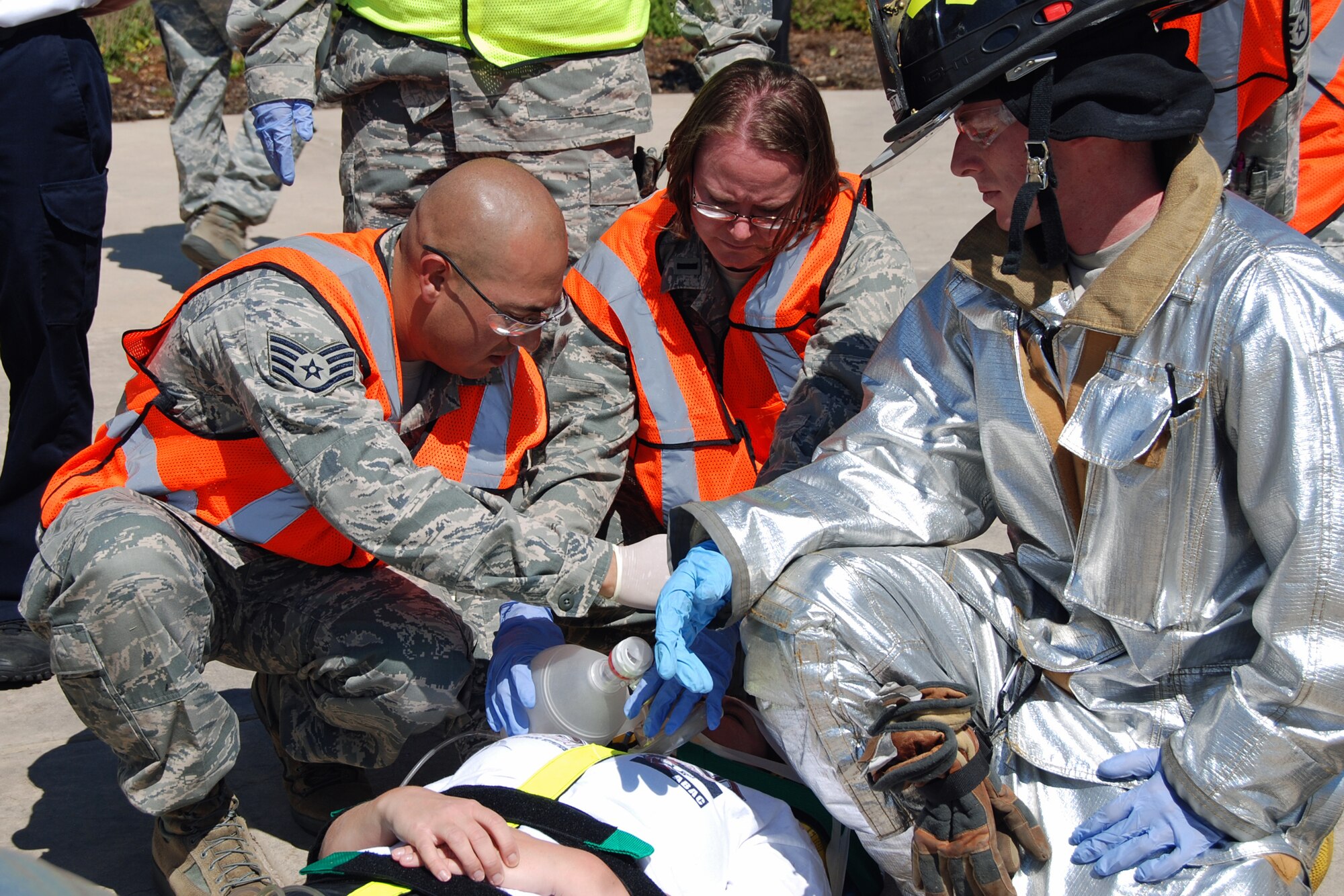 First responders treat the wounds of a shooting victim during an active shooter exercise scenario Aug. 28 near Building 2. The Condor Crest emergency response exercise was held Aug. 26-30 as part of the 21st Space Wing's continued commitment to ensure base readiness. (U.S. Air Force photo/Lea Johnson)