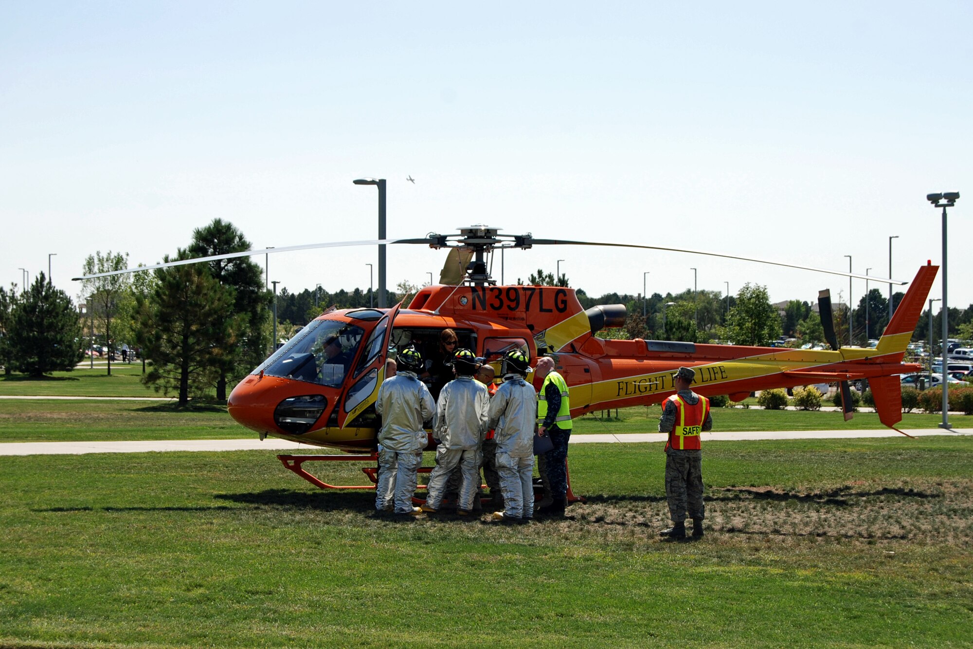 Flight for Life lands on the lawn in front of Building 2 to transport a shooting victim to an area hospital during an active shooter exercise scenario Aug. 28. The Condor Crest emergency response exercise was held Aug. 26-30 as part of the 21st Space Wing's continued commitment to ensure base readiness. (U.S. Air Force photo/Lea Johnson)