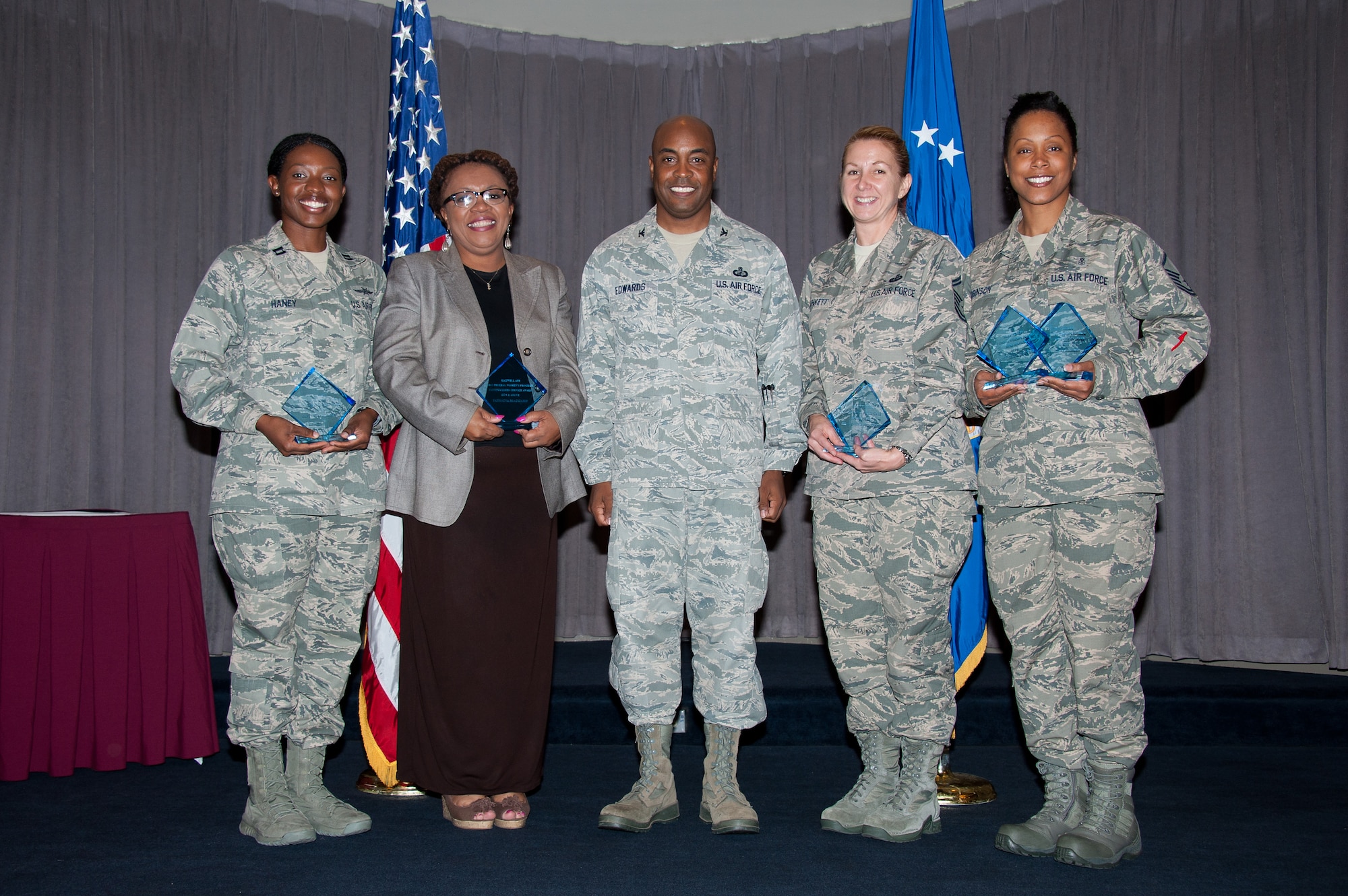 Col. Trent Edwards, commander of the 42nd Air Base Wing, center, stands with Federal Women’s Program award winners, from left, Capt. Ebony Haney, Dr. Patricia Maggard, Senior Master Sgt. Karen Plunkett and Master Sgt. Tammy Robinson.The FWP recognized women in the community for their leadership and service efforts during a luncheon Aug. 23 at the Maxwell Club.