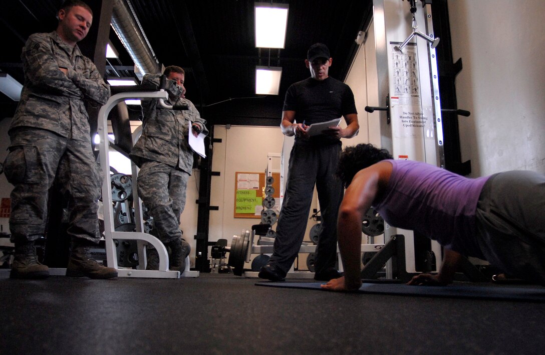 125th Fighter Wing Medical Service Journeyman, Staff Sgt. Mariam Abdallah, performs pushups as 125th Fighter Wing Health Promotions Officer, Captain Jesus Garcia (second from right) keeps count, as, 125th Fighter Wing, Jacksonville, Fla, August 18, 2012.  (looking on are 125th Fighter Wing Chaplain's Assistant, Senior Airman Winter and 125th Fighter Wing Chaplain First Lt. John Williams) (Air National Guard photo by MSgt. Shelley Gill)