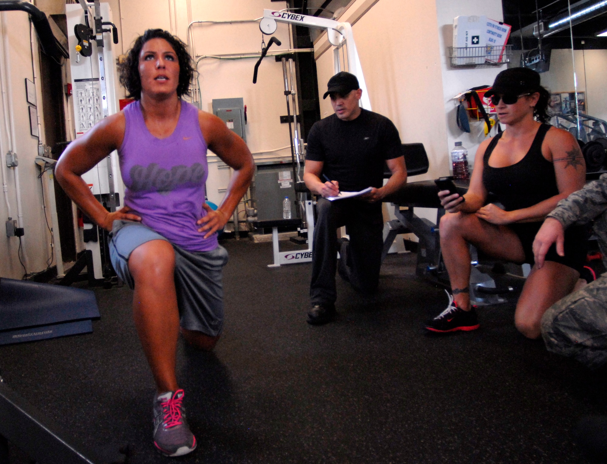 125th Fighter Wing Medical Service Journeyman, Staff Sgt. Mariam Abdallah, performs lunges as 125th Fighter Wing Health Promotions Officer, Captain Jesus Garcia (second from left) and his partner Christina Sox (second from right), owner of Crossfit Fortitude in South Daytona Beach, keep time and count, 125th Fighter Wing, Jacksonville, Fla, August 18, 2012. Garcia and Sox have developed an easy to follow fitness plan utilizing Tabata, a high intensity interval training tool aimed to help members of the 125th Fighter Wing, Florida Air National Guard meet their fitness goals.  (Air National Guard photo by MSgt. Shelley Gill)