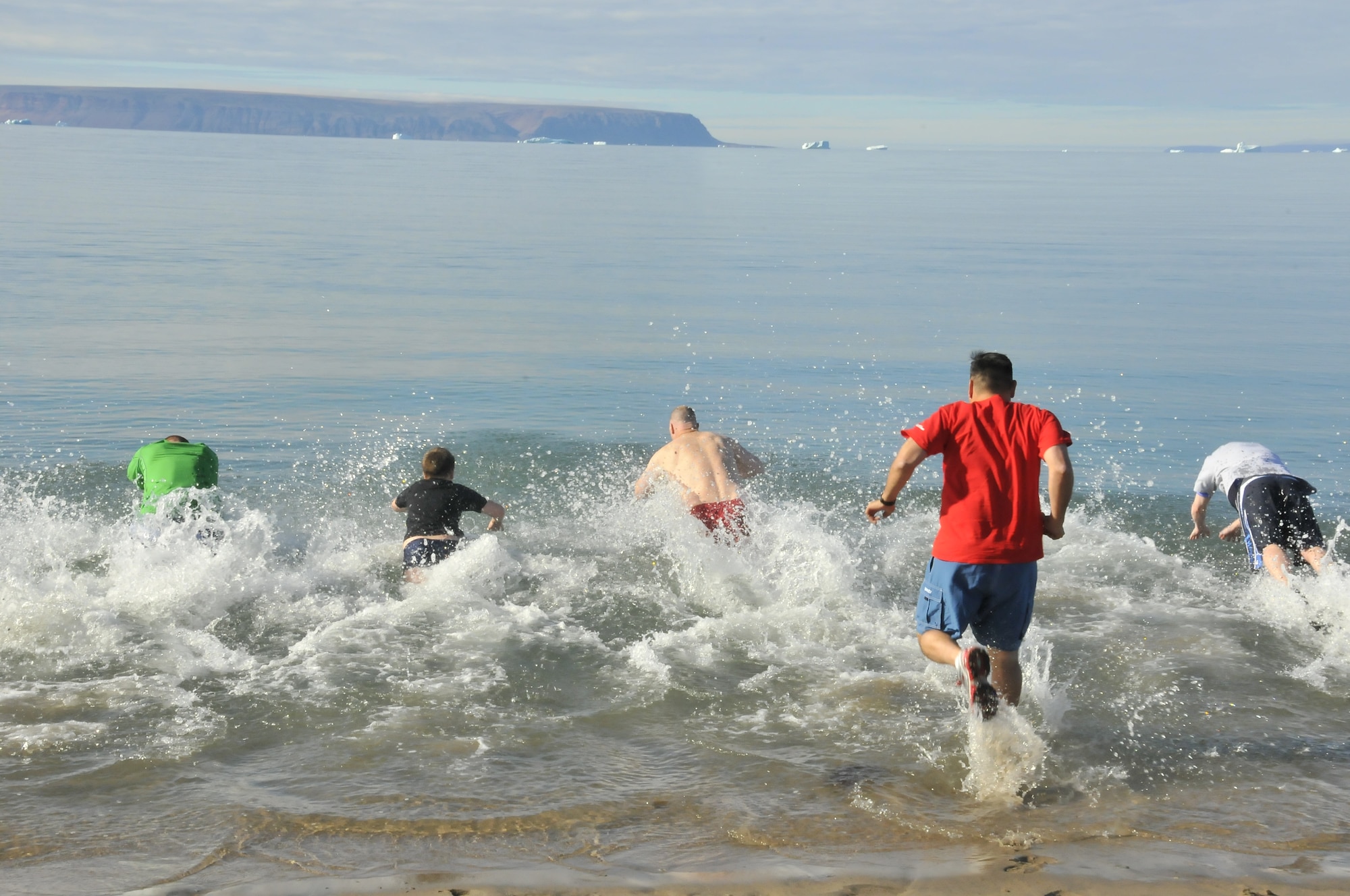 THULE AIR BASE, Greenland – Icebergs float on the horizon as 821st Air Base Group Airmen hold a polar bear swim Aug. 4 and 26 at the Thule AB Tug Boat Beach. The air temperature was 51 degrees, while the water was a scant 41 degrees. "It was a really unique experience,” said a chilled Staff Sgt. Neal Thompson, 821st Air Base Group Knowledge Operations Management. “It was definitely something that a lot of people are unable to do,” he said referring to his newly-earned title of Polar Bear. Thule AB is one of the six installations operated by the 21st Space Wing, and is located 750 miles north of the Arctic Circle. (U.S. Air Force photo/ Staff Sgt. Laura Vargas)