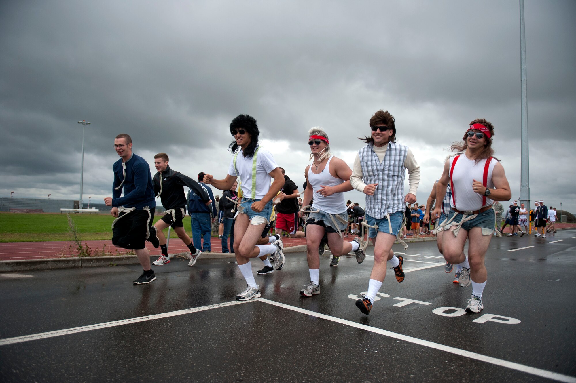 SPANGDAHLEM AIR BASE, Germany – Airmen of the 52nd Fighter Wing take off from the starting line during a 52nd Logistics Readiness Squadron zombie 5K fundraiser here Aug. 31.  Base members dressed as zombies and chased runners, who competed for time against other groups to complete a series of obstacles.  Players were outfitted with pieces of fabric to represent lives.  Once a runner was out of lives, they became a zombie, and chased runners who crossed their path. (U.S. Air Force photo by Airman 1st Class Gustavo Castillo/Released)