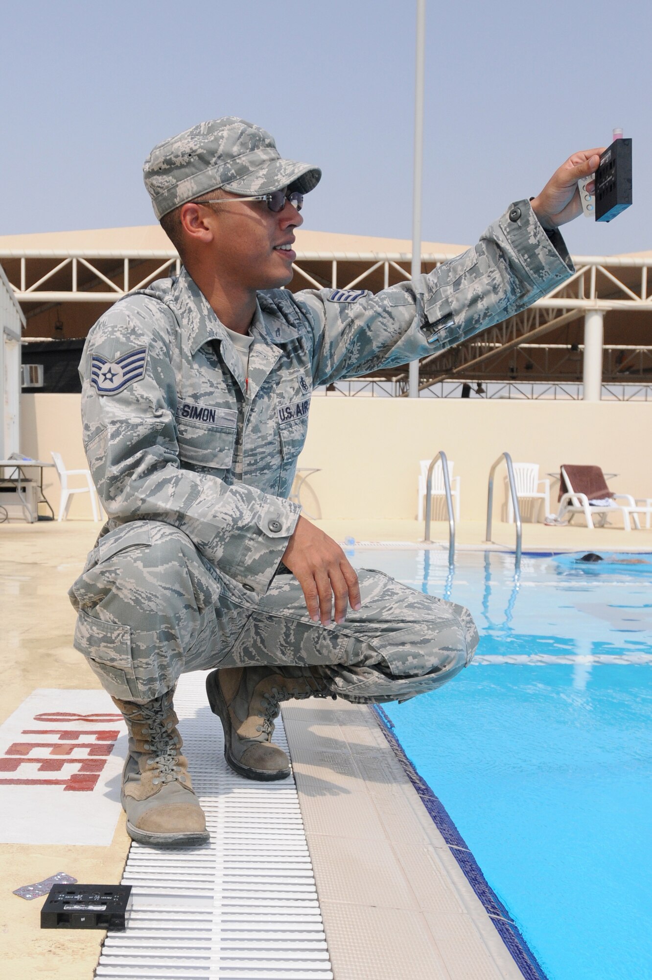 SOUTHWEST ASIA -- U.S. Air Force Staff Sgt. Larry Simon, 380th Expeditionary Medical Group Bioenvironmental Engineering technician, checks water in the pool here for chlorine and pH levels Sept. 3, 2012. Simon, a Davenport, Iowa, native, is deployed to the 380th Air Expeditionary Wing from Offutt Air Force Base, Neb. (U.S. Air Force photo/Tech. Sgt. Amanda Savannah)
