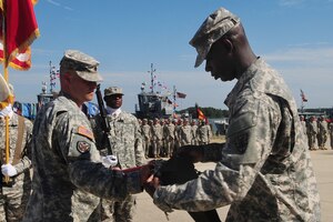 U.S. Army Lt. Col. Curt L. Stewart, 6th Transportation Battalion, 7th Sustainment Brigade commander, left, assists Command Sgt. Maj. Anthony Bargaineer of the 6th Trans. Bn. as he furls the colors during an inactivation ceremony at Fort Eustis, Va. Aug. 28, 2012. The unit first activated at Fort Eustis 60 years ago, standing up Aug. 15, 1952 and serving in World War II, Vietnam, and Operations Restore Hope and New Dawn. (U.S. Air Force photo by Staff Sgt. Ashley Hawkins/Released)