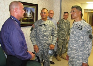 Dr. Paul Duch (left), Integrated Disability Examination System medical director, oversees the benefits processing for wounded, ill and injured service members. He recently met with Brig. Gen. Joseph Caravalho, Jr., commanding general, Northern Regional Medical Command, Fort Belvoir, Va., and explained how Soldiers benefit from using IDES. (Courtesy photo by Marlon J. Martin/Released)