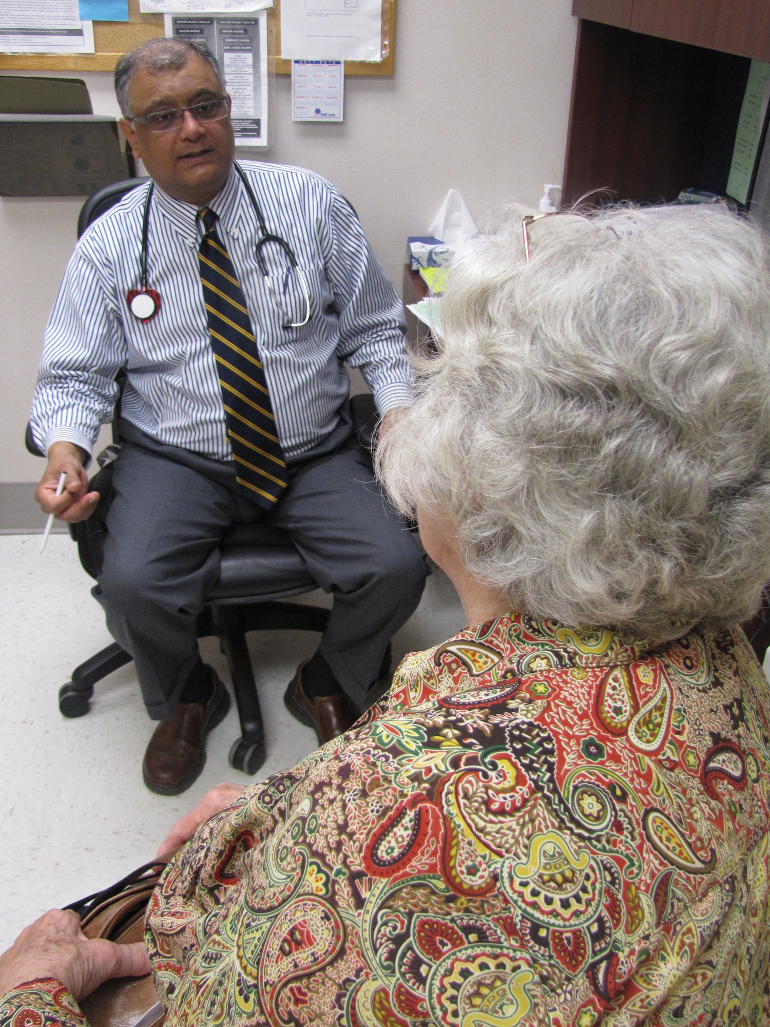 Dr. Khalid A. Khan, Internal Medicine staff internist, speaks to a patient during her recent visit to the McDonald Army Health Center at Fort Eustis, Va..  Internal Medicine is one of four primary care clinics that will offer Patient Centered Medical Home services -- a new model of healthcare that has been adopted throughout the military healthcare system. (Courtesy photo by Marlon Martin/Released) 