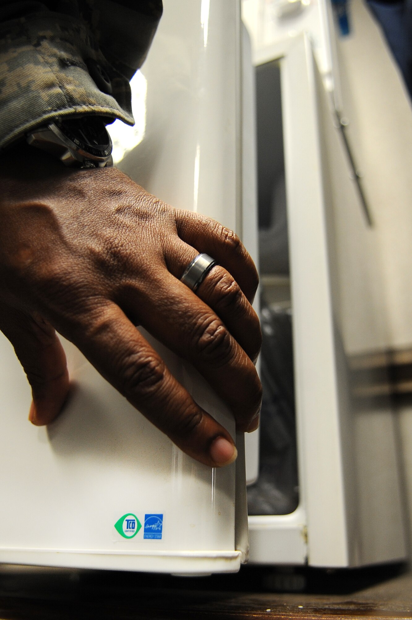 An Airman opens an Energy-Star efficient, miniature refrigerator on Seymour Johnson Air Force Base, N.C., Aug. 29, 2012. Products containing the Energy Star label meet specific efficiency guidelines set by the U.S. Department of Energy and the Environmental Protection Agency. (U.S. Air Force photo/Airman 1st Class Aubrey Robinson/Released)