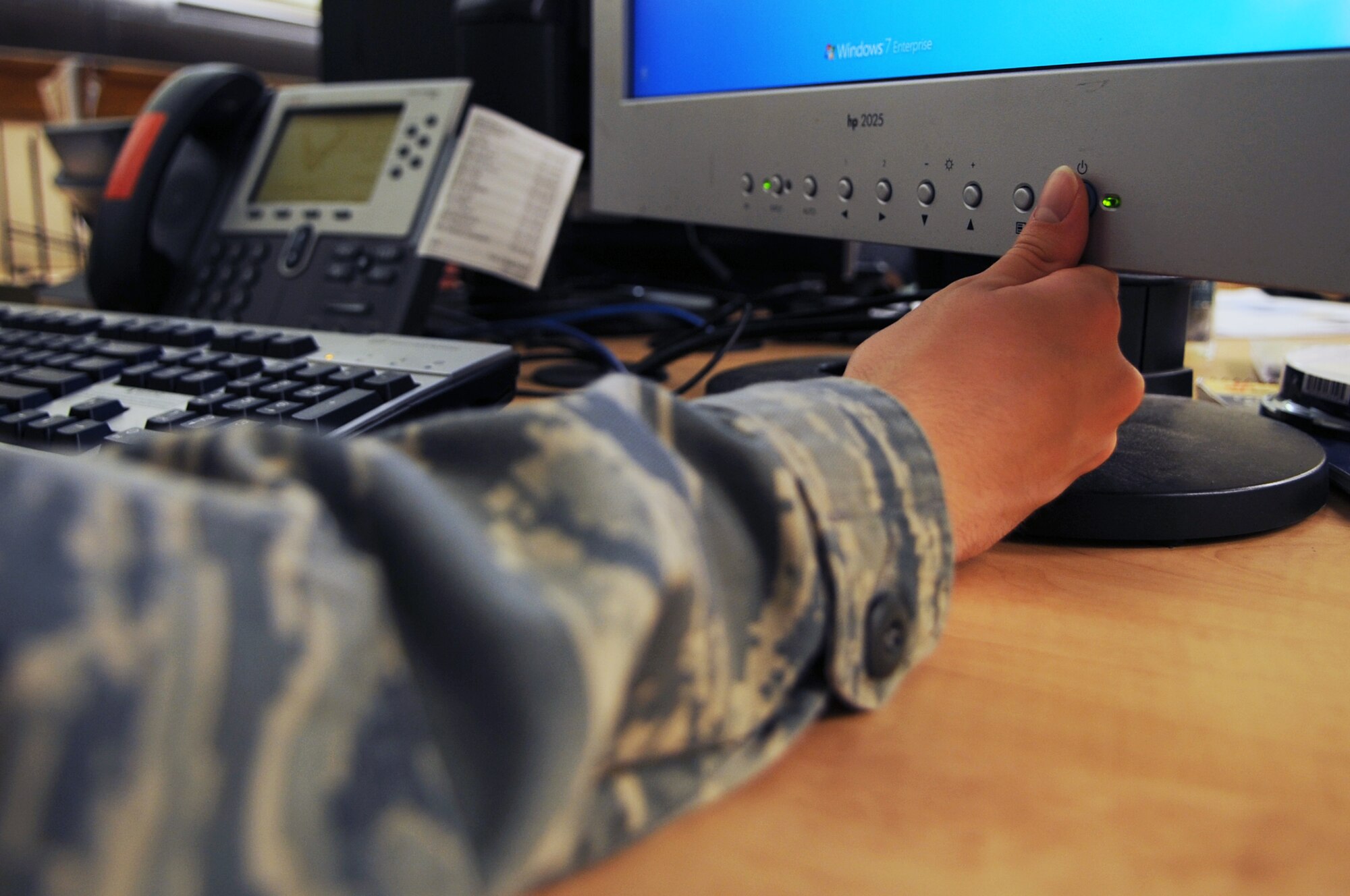An Airman attempts to turn off a computer monitor on Seymour Johnson Air Force Base, N.C., Aug. 29, 2012. Turning off computer monitors when not in use can assist in efforts to conserve energy and save money. (U.S. Air Force photo/Airman 1st Class Aubrey Robinson/Released)