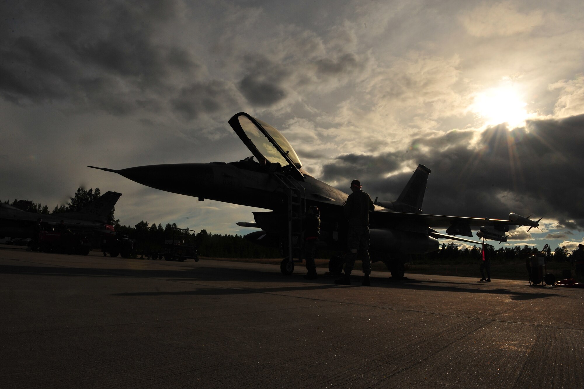 KALLAX AIR BASE, Sweden -- Maj. Brian Scott, 480th Fighter Squadron pilot, exits the cockpit of his assigned F-16 Fighting Falcon aircraft here Sept. 3 after a flight at the Nordic Air Meet 2012. The multinational training exercise brought together more than 50 aircraft from the United States, Great Britain, Denmark, Finland, Switzerland and Sweden to participate in tactical role-playing training missions. The three week exercise enabled the different nations to exchange aerial tactics and capabilities to improve combat power effectiveness in solo and joint environments while building and strengthening international partnerships. (U.S. Air Force Photo by Airman 1st Class Dillon Davis/Released)