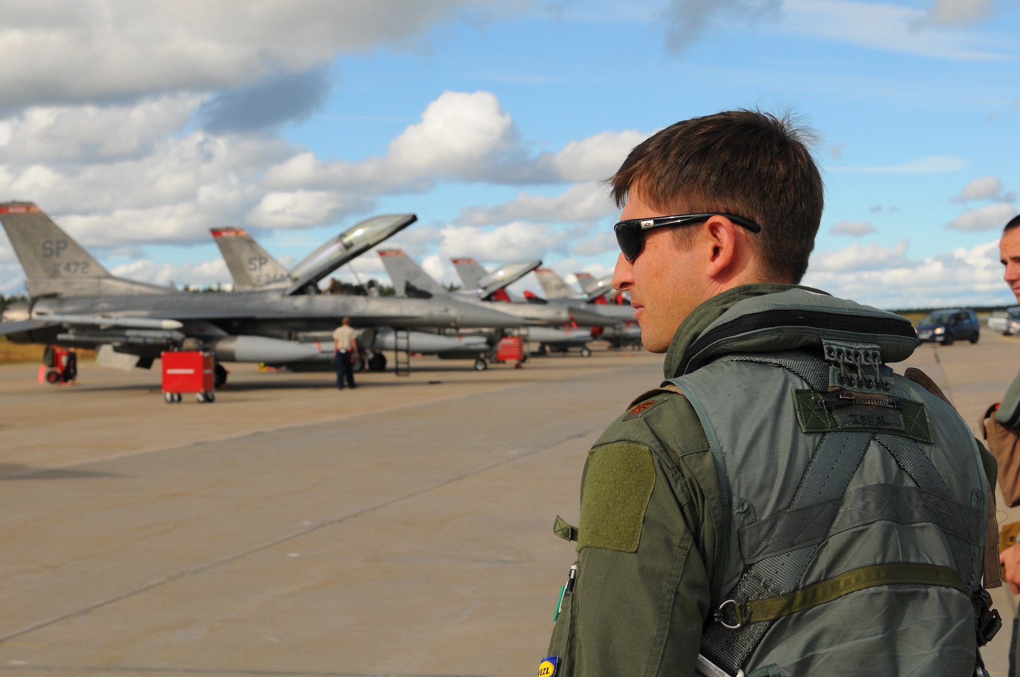 KALLAX AIR BASE, Sweden -- Maj. Brian Scott, 480th Fighter Squadron pilot, approaches his assigned F-16 Fighting Falcon aircraft before a flight here Sept. 3 at the Nordic Air Meet 2012. The multinational training exercise brought together more than 50 aircraft from the United States, Great Britain, Denmark, Finland, Switzerland and Sweden to participate in tactical role-playing training missions. The three week exercise enabled the different nations to exchange aerial tactics and capabilities to improve combat power effectiveness in solo and joint environments while building and strengthening international partnerships. (U.S. Air Force Photo by Airman 1st Class Dillon Davis/Released)