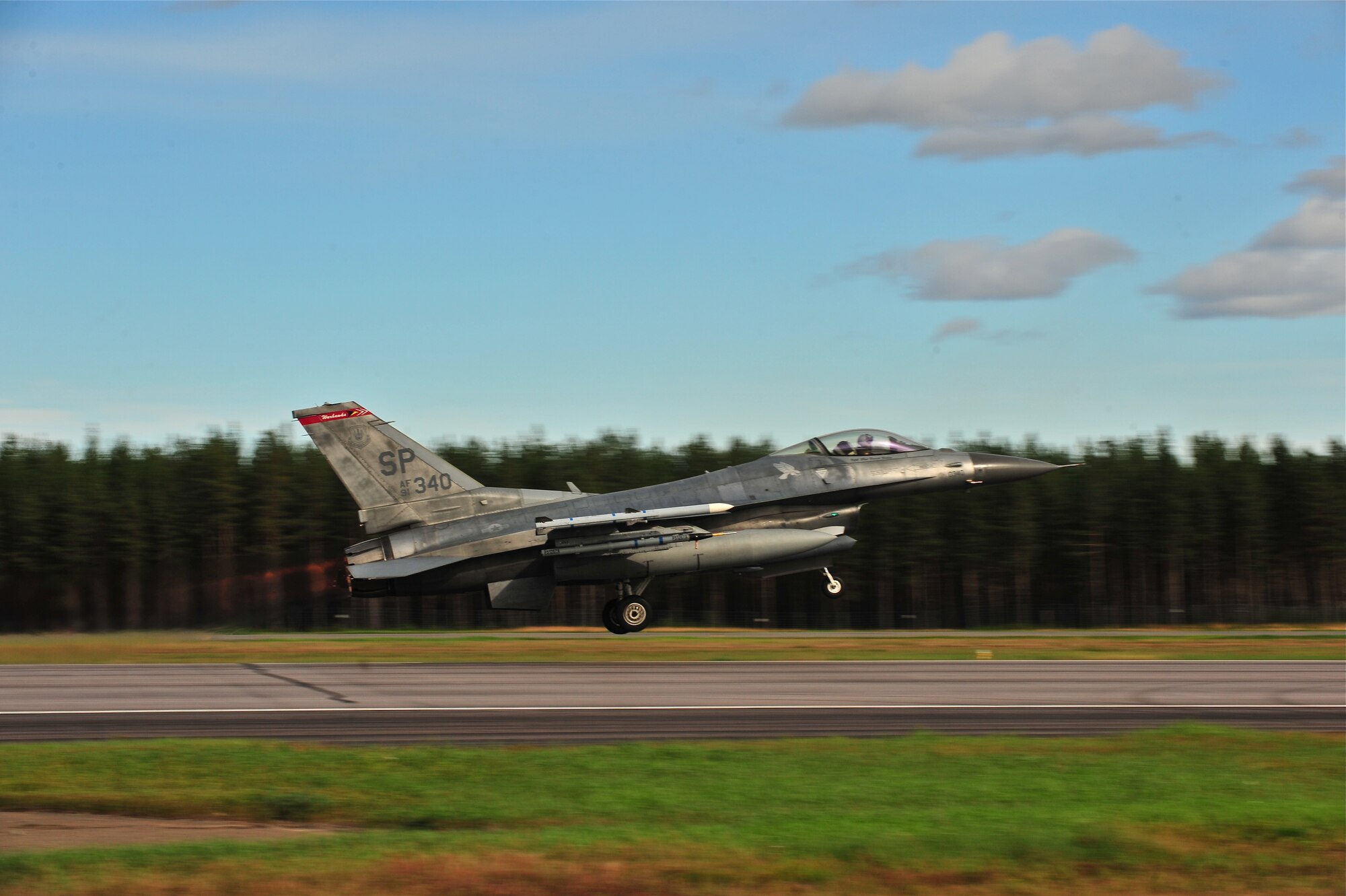 KALLAX AIR BASE, Sweden -- Maj. Brian Scott, 480th Fighter Squadron pilot, takes off from the runway in an F-16 Fighting Falcon aircraft here Sept. 3 during a flight at the Nordic Air Meet 2012. The multinational training exercise brought together more than 50 aircraft from the United States, Great Britain, Denmark, Finland, Switzerland and Sweden to participate in tactical role-playing training missions. The three week exercise enabled the different nations to exchange aerial tactics and capabilities to improve combat power effectiveness in solo and joint environments while building and strengthening international partnerships. (U.S. Air Force Photo by Airman 1st Class Dillon Davis/Released)