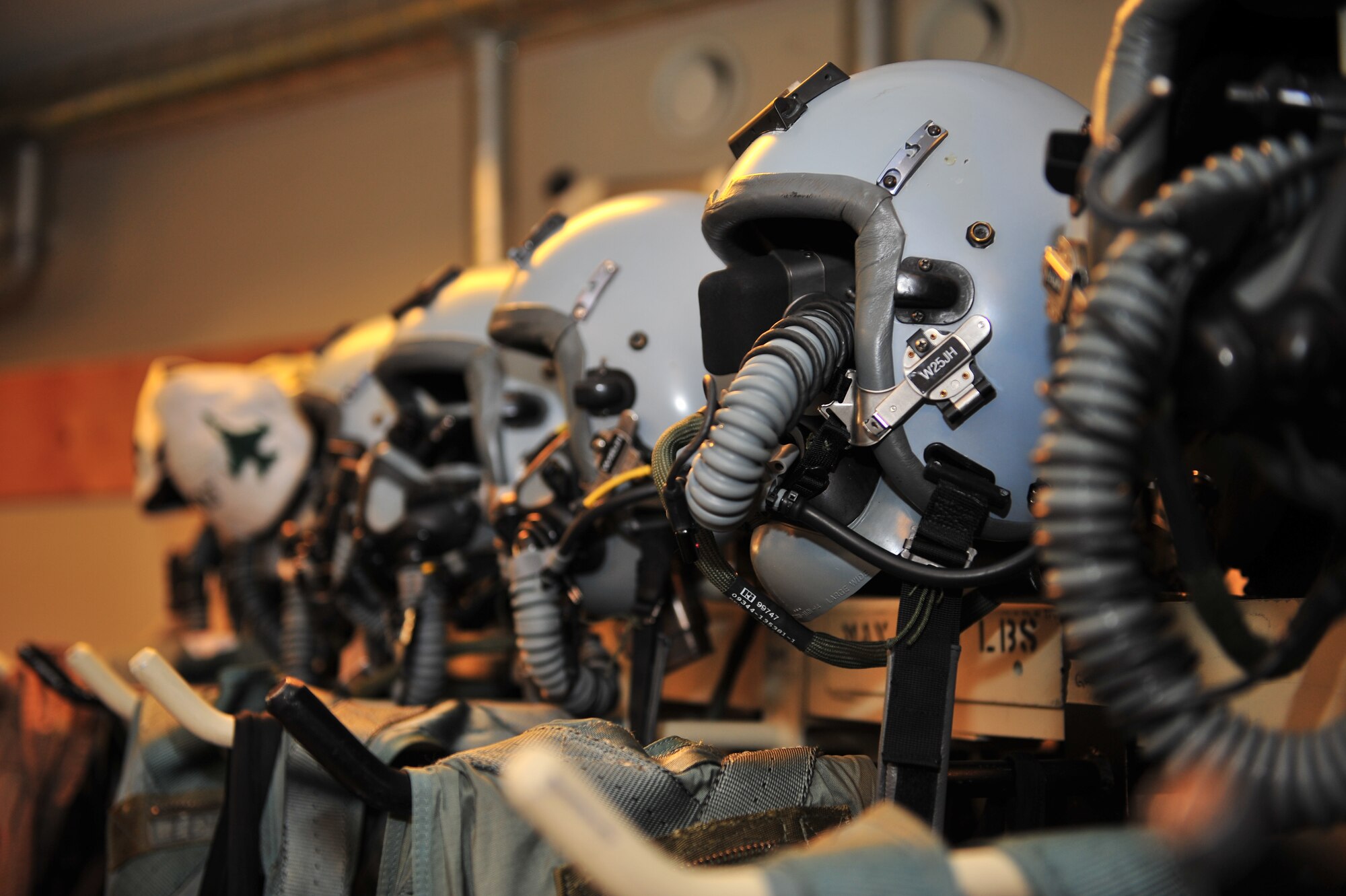 KALLAX AIR BASE, Sweden -- Flight helmets belonging to 480th Fighter Squadron pilots rest in a row on top of a shelf during the Nordic Air Meet 2012 here Sept. 3. The multinational training exercise brought together more than 50 aircraft from the United States, Great Britain, Denmark, Finland, Switzerland and Sweden to participate in tactical role-playing training missions. The three week exercise enabled the different nations to exchange aerial tactics and capabilities to improve combat power effectiveness in solo and joint environments while building and strengthening international partnerships. (U.S. Air Force Photo by Airman 1st Class Dillon Davis/Released)