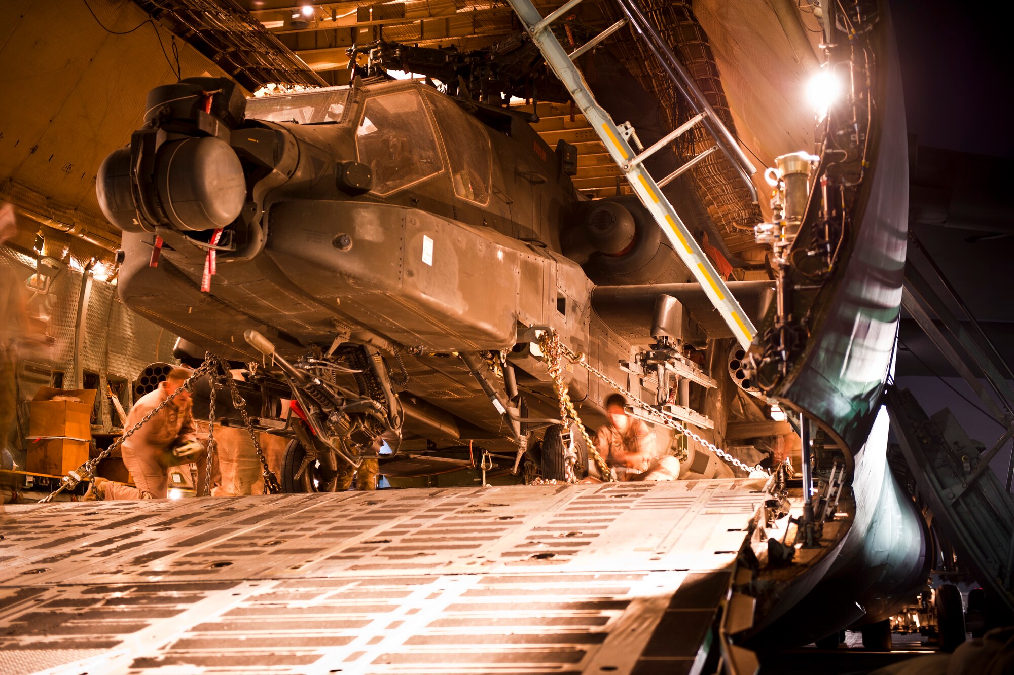 Airmen and Soldiers secure the evening’s fourth and the final U.S. Army AH-64 Apache attack helicopter aboard a U.S. Air Force C-5B Galaxy at Bagram Airfield, Afghanistan Aug. 31, 2012. It took the team approximately four hours to completely unload and load the massive aircraft before its early-morning departure. (U.S. Air Force Photo/Capt. Raymond Geoffroy)