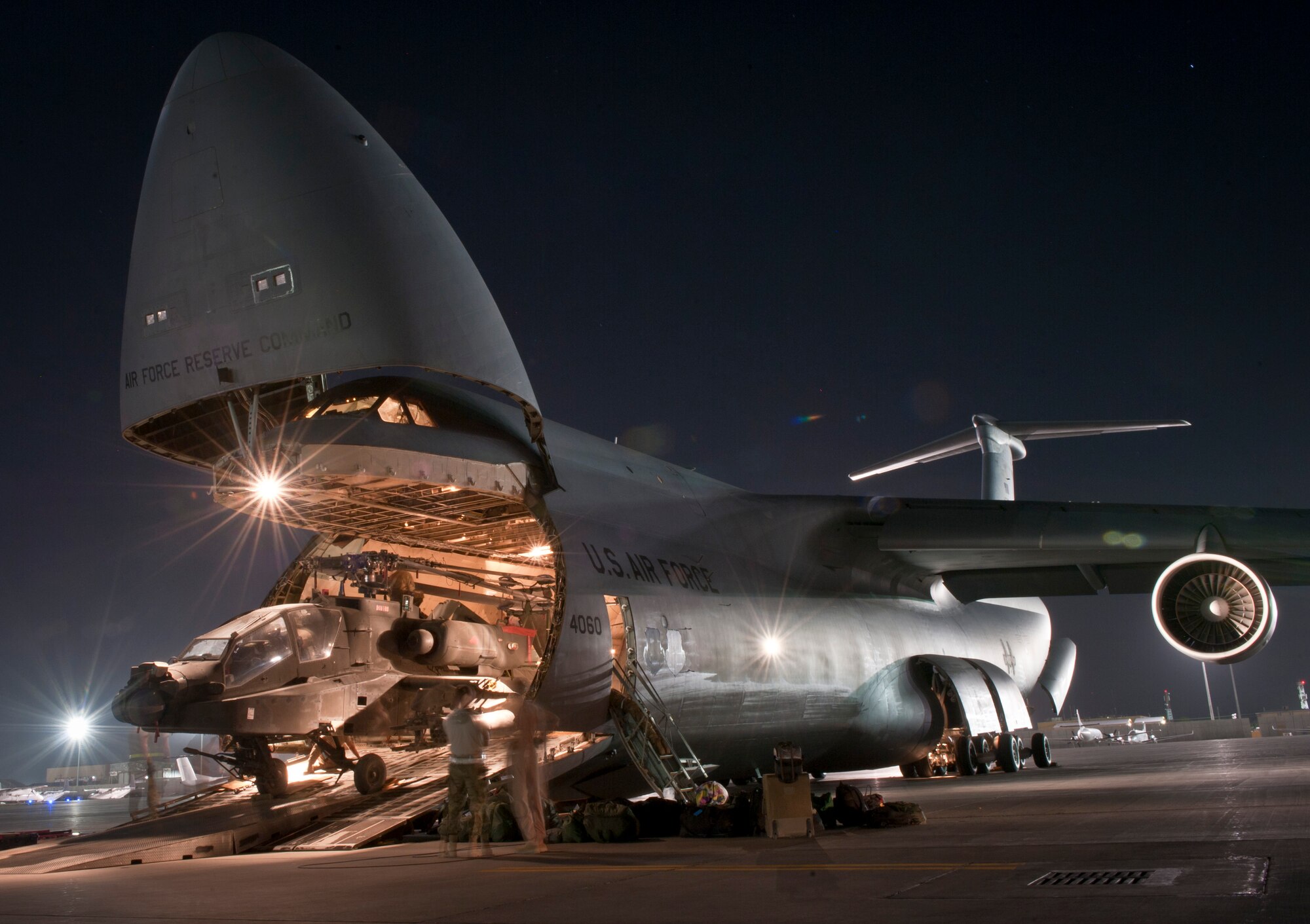 Airmen and Soldiers load a U.S. Army AH-64 Apache attack helicopter aboard a U.S. Air Force C-5B Galaxy at Bagram Airfield, Afghanistan Aug. 31, 2012. C-5 Aircrews and maintainers from the West Virginia Air National Guard’s 167th Airlift Wing were positioned at Bagram to assist in the Relief in Place/Transfer of Authority from the departing 82nd Combat Aviation Brigade and arriving 101st Combat Aviation Brigade. (U.S. Air Force Photo/Capt. Raymond Geoffroy)