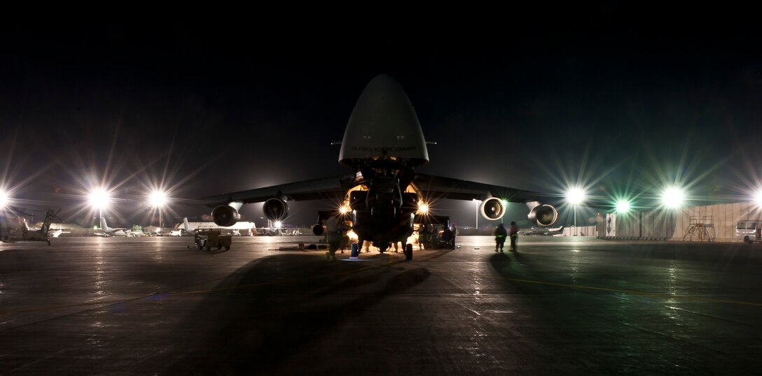 Airmen and Soldiers load a U.S. Army AH-64 Apache attack helicopter aboard a U.S. Air Force C-5B Galaxy at Bagram Airfield, Afghanistan Aug. 31, 2012. C-5 Aircrews and maintainers from the West Virginia Air National Guard’s 167th Airlift Wing were positioned at Bagram to assist in the Relief in Place/Transfer of Authority from the departing 82nd Combat Aviation Brigade and arriving 101st Combat Aviation Brigade. (U.S. Air Force Photo/Capt. Raymond Geoffroy)