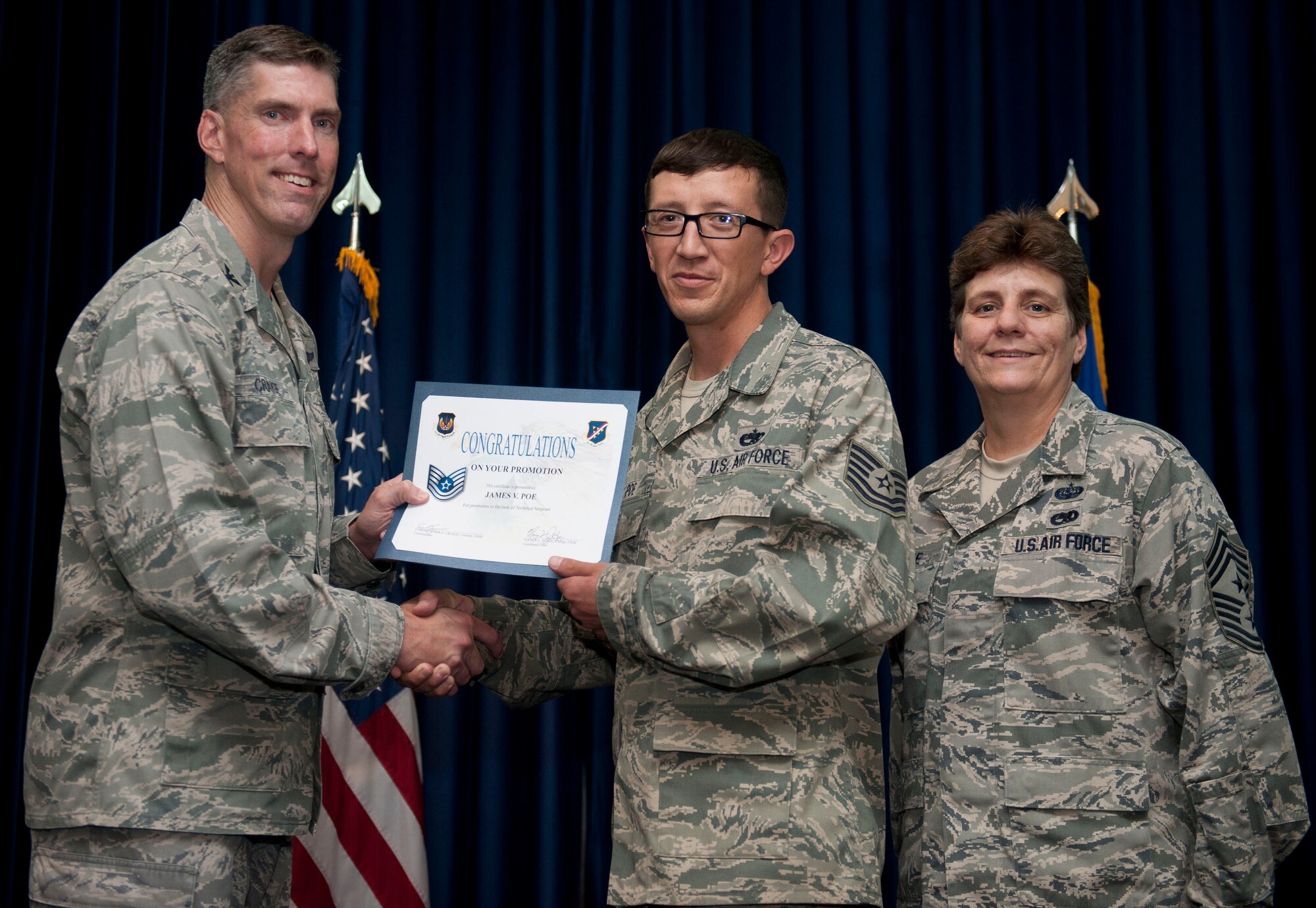 James Poe, 728th Air Mobility Squadron, is promoted to the rank of technical sergeant Aug. 31, 2012, at the club complex ballroom at Incirlik Air Base, Turkey. (U.S. Air Force photo by Senior Airman Clayton Lenhardt/Released)