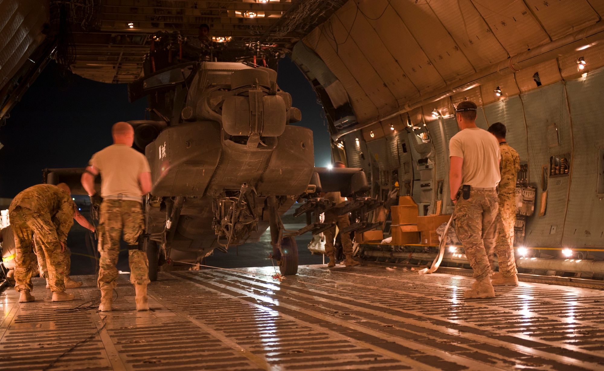 Airmen and Soldiers load a U.S. Army AH-64 Apache attack helicopter aboard a U.S. Air Force C-5B Galaxy at Bagram Airfield, Afghanistan Aug. 30, 2012. The C-5 can carry up to six Apache helicopters in a single load depending on configuration. The C-5’s payload capacity made it the ideal choice for the Relief in Place/Transfer of Authority process of the departing 82nd Combat Aviation Brigade and arriving 101st Combat Aviation Brigade. (U.S. Air Force Photo/Capt. Raymond Geoffroy)