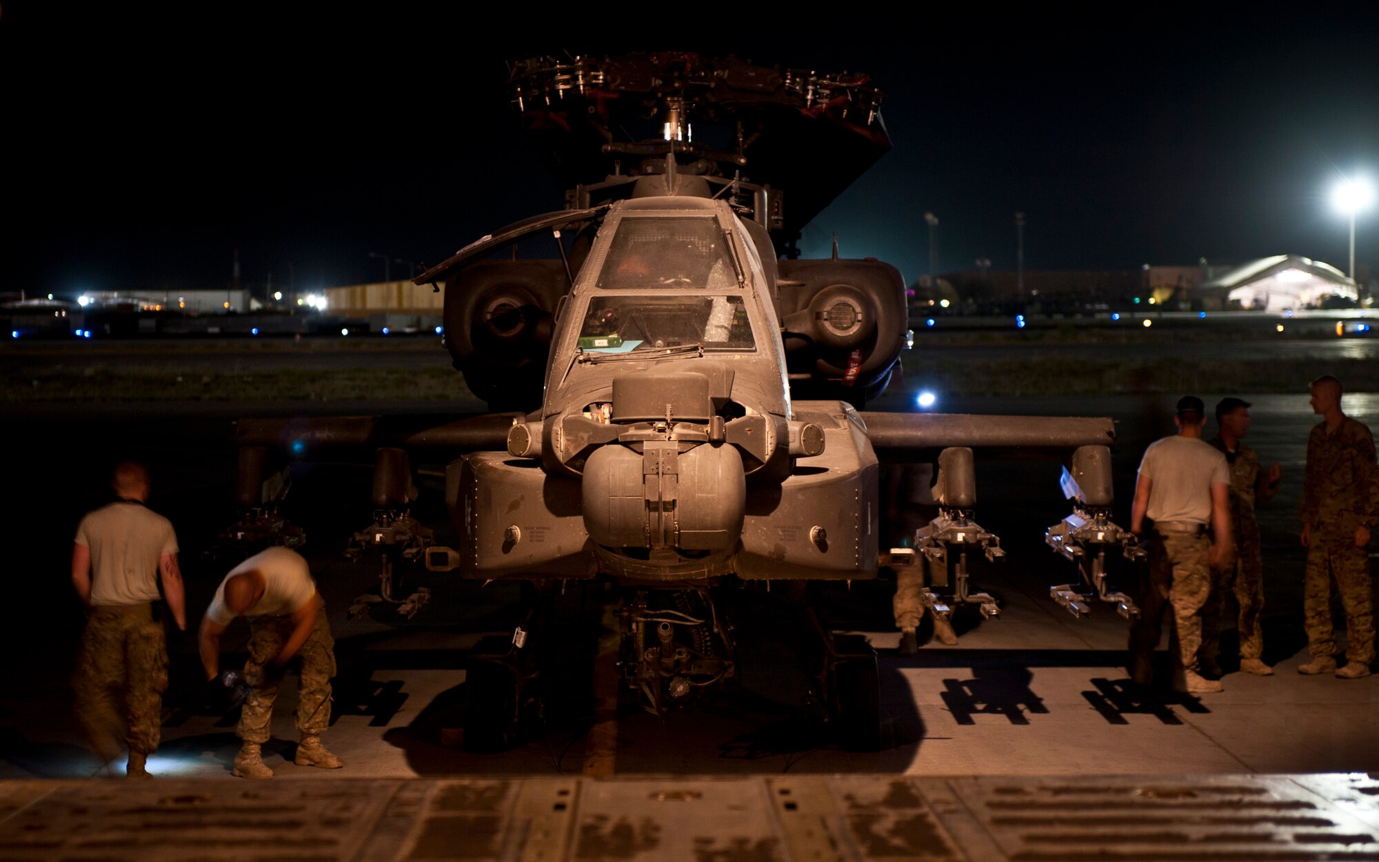 Airmen and Soldiers prepare to load a U.S. Army AH-64 Apache attack helicopter aboard a U.S. Air Force C-5B Galaxy at Bagram Airfield, Afghanistan Aug. 30, 2012. A joint team of Bagram Aerial Porters, West Virginia Air Guardsmen, and U.S. Army Soldiers worked seamlessly to transport dozens of rotary wing aircraft and thousands of pounds of equipment in and out of Afghanistan as the 101st Combat Aviation Brigade replaced the redeploying 82nd Combat Aviation Brigade. (U.S. Air Force Photo/Capt. Raymond Geoffroy)