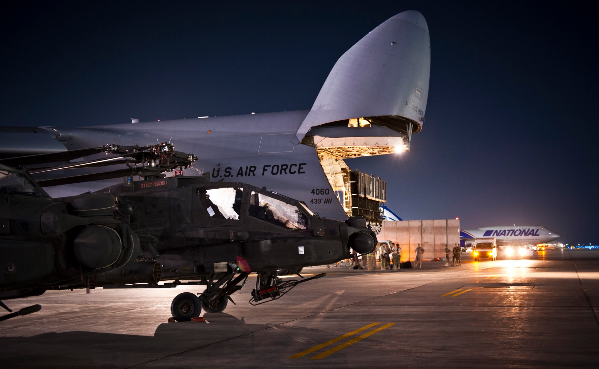 A line of U.S. Army AH-64 Apache attack helicopters sit ready to be loaded on a U.S. Air Force C-5B Galaxy at Bagram Airfield, Afghanistan Aug. 30, 2012. The C-5 can carry up to six Apache helicopters in a single load depending on configuration. The C-5’s payload capacity made it the ideal choice for the Relief in Place/Transfer of Authority process of the departing 82nd Combat Aviation Brigade and arriving 101st Combat Aviation Brigade. (U.S. Air Force Photo/Capt. Raymond Geoffroy)