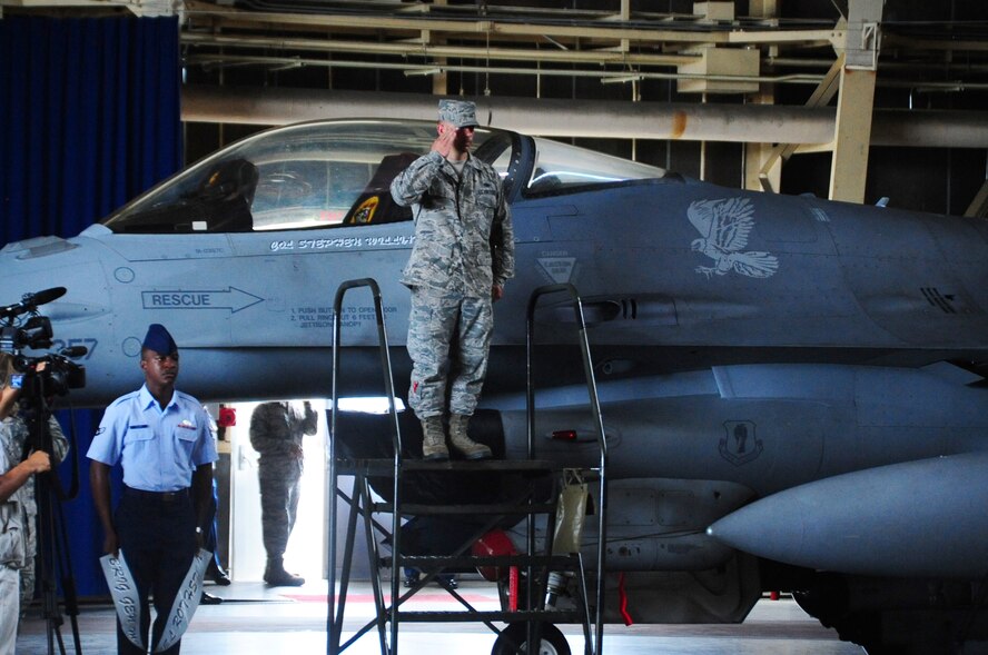 U.S. Air Force Staff Sgt. Donald Slayton, 35th Aircraft Maintenance Squadron crew chief, salutes Col. Stephen Williams, 35th Fighter Wing commander, after revealing his name on a F-16 Fighting Falcon at Misawa Air Base, Japan, Sept. 4, 2012.  Williams is a command pilot with more than 2,800 flying hours, including more than 260 combat hours.  (U.S. Air Force photo by Staff Sgt. April Quintanilla)