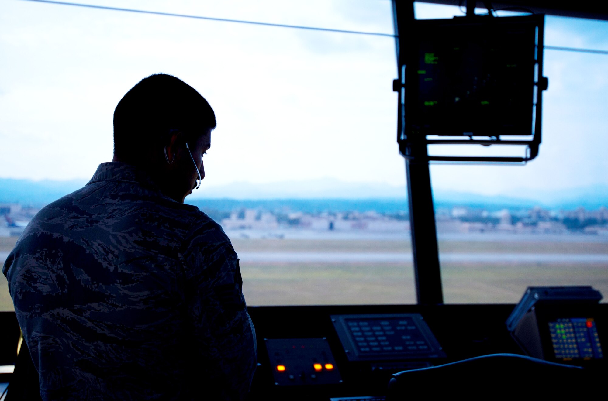 YOKOTA AIR BASE, Japan – Staff Sgt. Bryan Bentley, 374th Operations Support Squadron air traffic controller, watches the Yokota flightline from the air traffic control tower Aug. 29, 2012. The 374 OSS and Japan Air Self-Defense Force work together to control the airspace of approximately 60 nautical miles. (U.S. Air Force photo by Staff Sgt. Chad C. Strohmeyer)