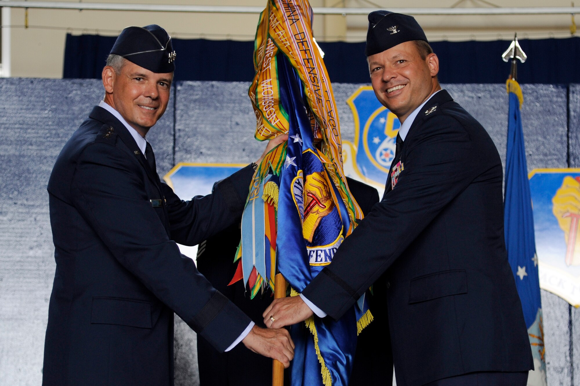 U.S. Air Force Lt. Gen. Sam Angelella, left, U.S. Forces, Japan and 5th Air Force commander, passes the wing guidon to Col. Stephen Williams, 35th Fighter Wing commander, during an official change of command ceremony at Misawa Air Base, Japan, Sept. 4, 2012. The guidon symbolizes the relinquishment of command from the outgoing commander to the incoming commander. Col. Williams comes to Misawa from Kunsan Air Base, Republic of Korea where he served as the 8th Fighter Wing vice commander. (U.S. Air Force photo by Tech. Sgt. Marie Brown)
