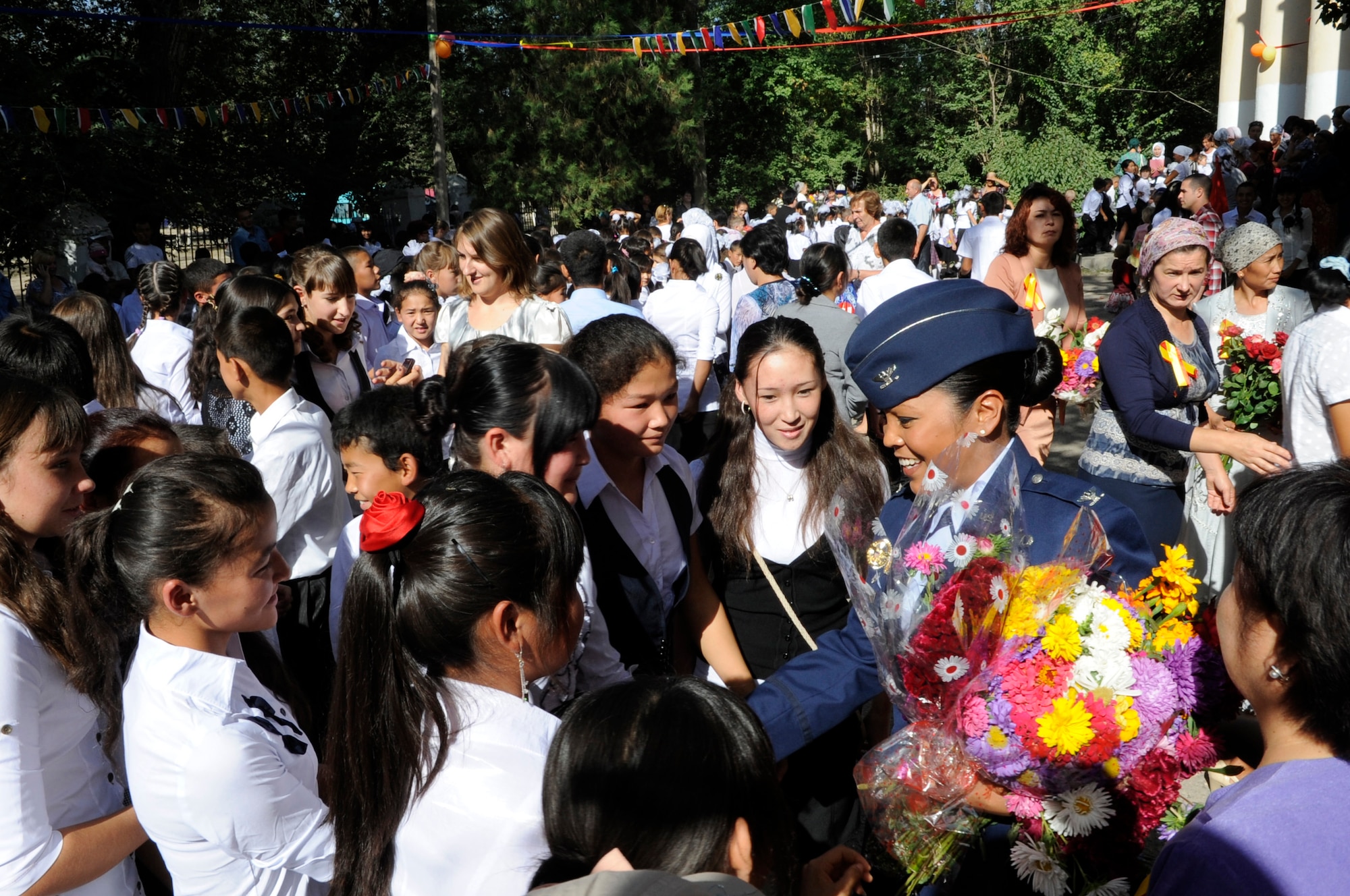 Col. Shirlene Ostrov meets with students from Niznechuiskiy School 1 to help celebrate the "First Bell" ceremony, Niznechuiskiy Village, Kyrgyzstan, Sept. 1, 2012.  Ostrov who is the 376th Expeditionary Mission Support Group commander and a native of Honolulu was in attendance as a guest speaker for the ceremony. First Bell is a Russian tradition and takes place each year on Sept. 1st to signal the first day of school. (U.S. Air Force photo/Master Sgt. Jason Vaught)