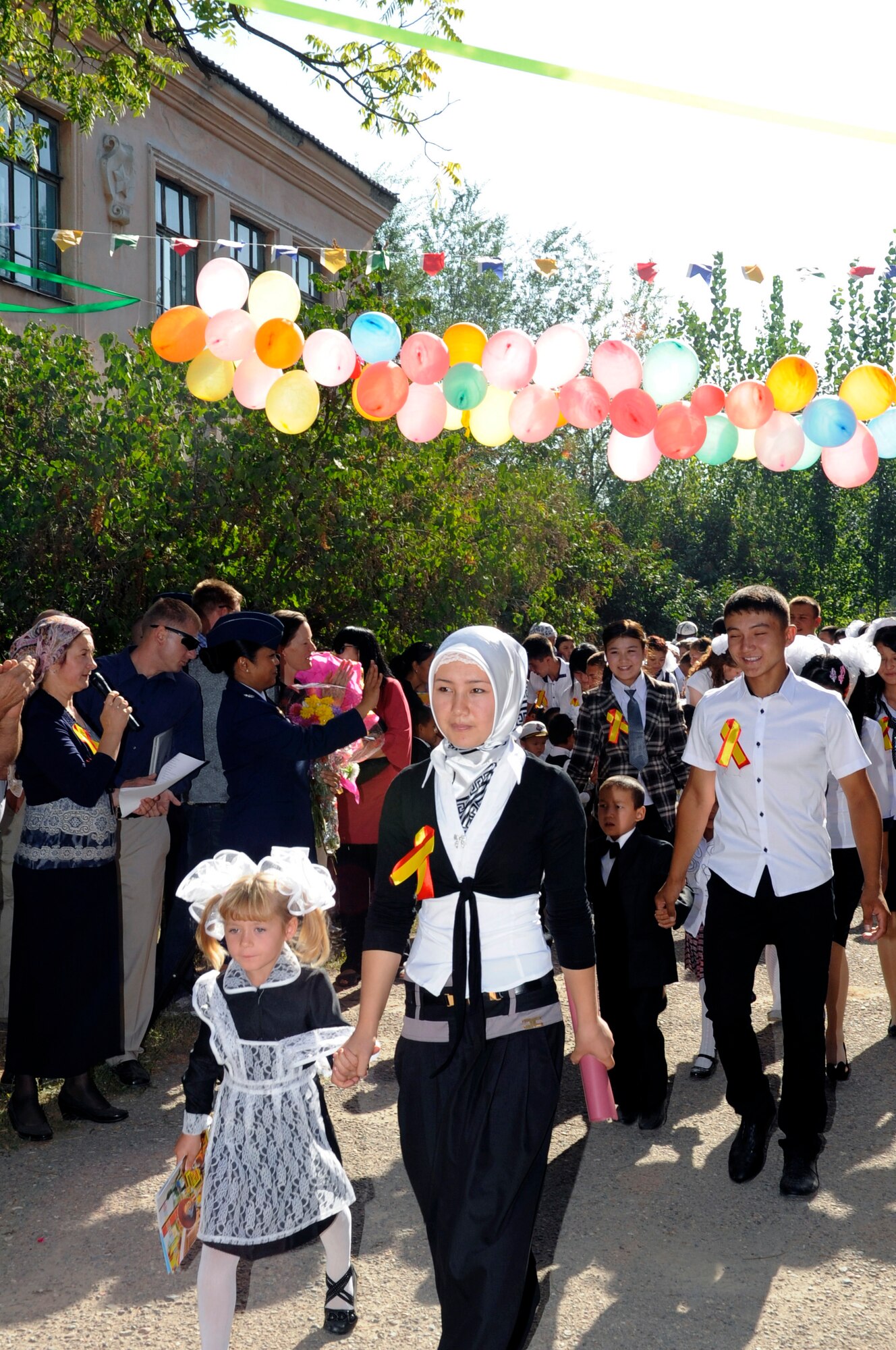 Seniors in their last year of school escort first-year students to class during the "First Bell" ceremony, Niznechuiskiy Village, Kyrgyzstan, Sept. 1, 2012.  First Bell is deeply rooted in Russian tradition and takes place each year on Sept. 1 to signal the first day of school. First Bell marks a rite of passage where seniors escort the first-year students in a ceremony symbolizing the start of a new school year. (U.S. Air Force photo/Master Sgt. Jason Vaught)