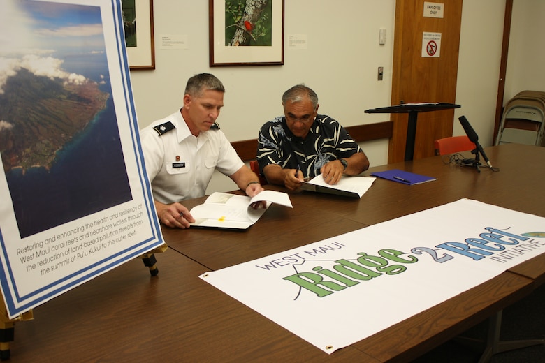 DLNR Chairperson, William J. Aila, Jr. (right) and Lt. Col. Thomas D. Asbery, commander, U.S. Army Corps of Engineers, Honolulu District, today signed a $3 million cost-share agreement to develop a watershed plan to support the West Maui “Ridge to Reef” Initiative.  The Initiative is one of the first efforts in the state to implement a comprehensive management strategy to address impacts to coral reefs across multiple watersheds.  The watershed plan will be funded 75-percent by the Corps and 25-percent by DLNR. “The islands and reefs are connected; what we do on land affects the reef,”  Aila said “Recognizing this relationship, the State understands that an integrated and comprehensive approach to reduce land-based sources of pollution is one of the most important steps to help restore coral reef ecosystems.  Healthy coral reefs are vital to our island lifestyle, economy, and a thriving Native Hawaiian culture.” 