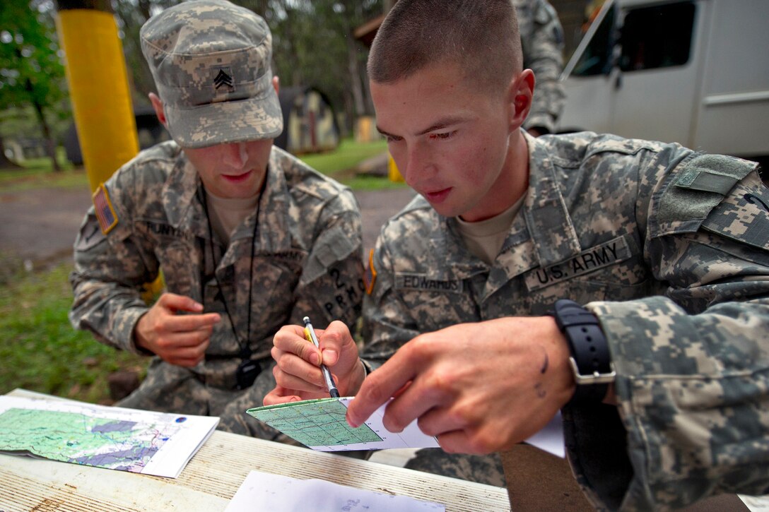 Army Sgts. Justin Runyan, left, and Robert Edwards plot points on a map before 
departing on a five hour land navigation test during the 2012 Pacific Regional Medical Command Best Medic Competition on Schofield Barracks in Wahiawa, Hawaii, Aug. 29, 2012. Runyan and Edwards, both combat medics, are assigned to Schofield Barracks Health Clinic. The 72-hour event is a physical and mental test of leadership, teamwork, tactics, medical knowledge and warrior skills.